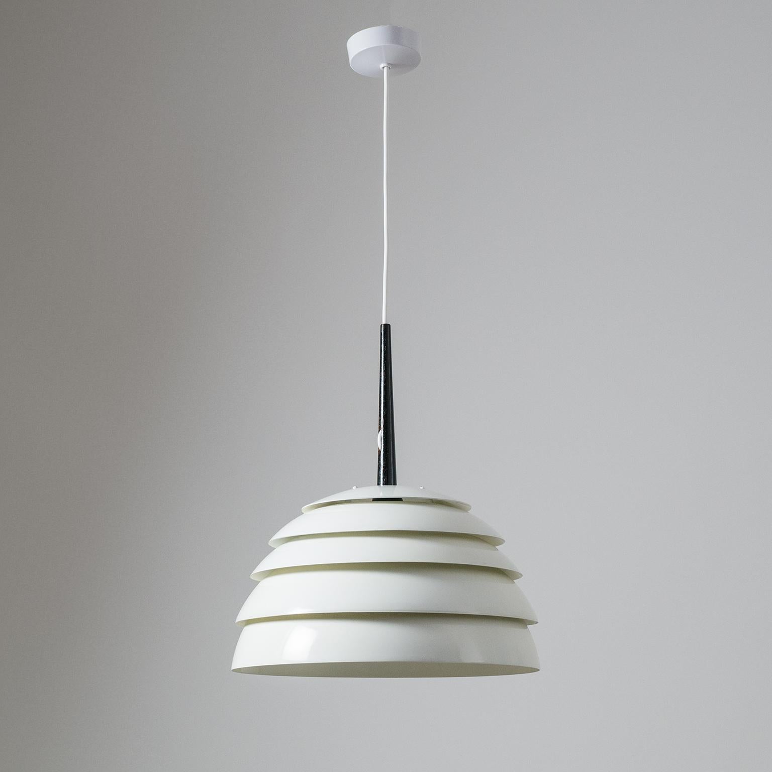 Rare white 'beehive' pendant by Hans-Agne Jakobsson, circa 1960, with stained teak detail. Five stacked and white lacquered metal shades are spaced with a slight gap allowing the light to seep out in between. One E27 socket with new wiring and