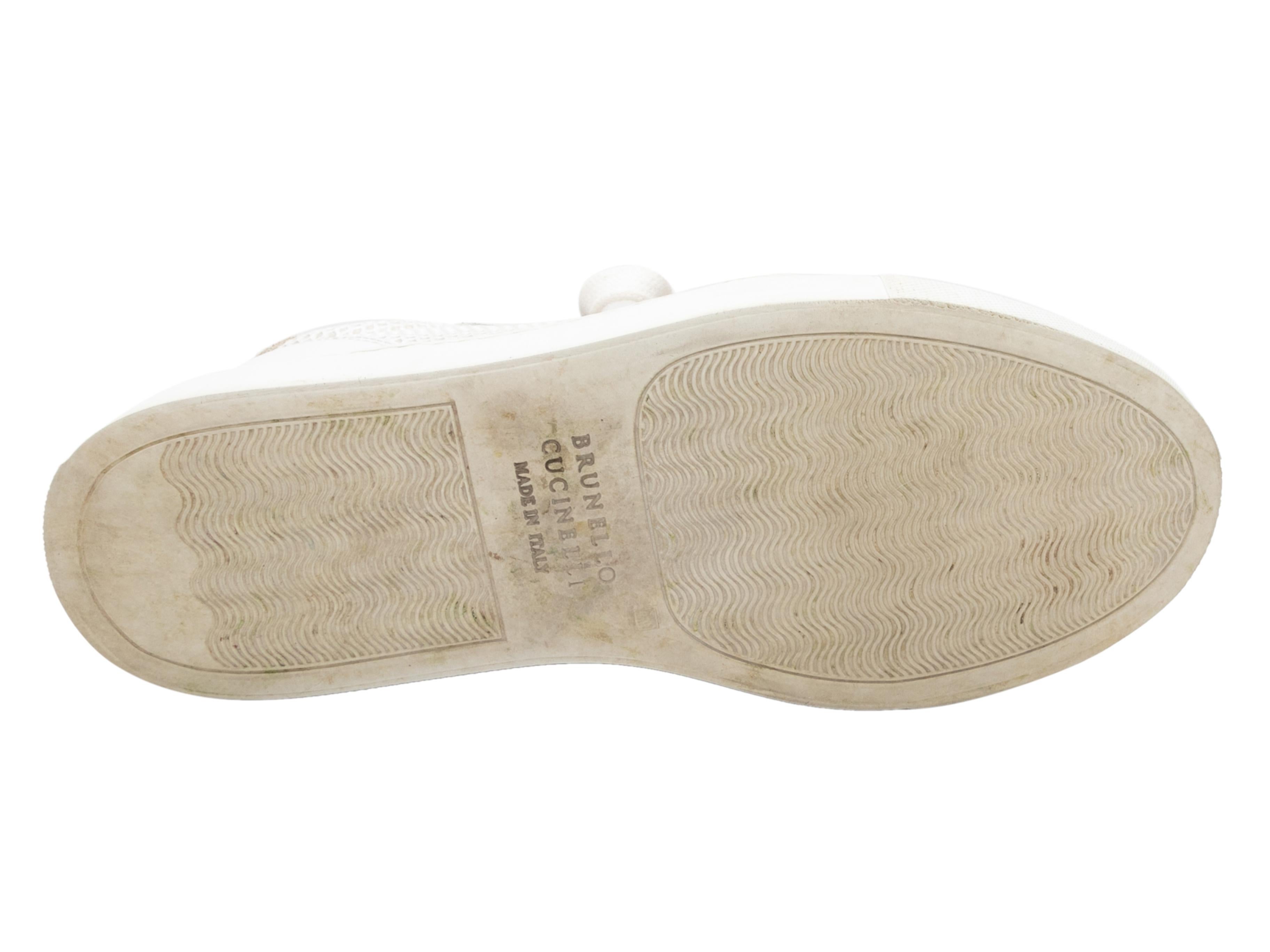 White and beige leather and suede low-top sneakers by Brunello Cucinelli. Silver-tone Monilli trim at tops. Rubber soles. Lace-up tie closures at tops. 1