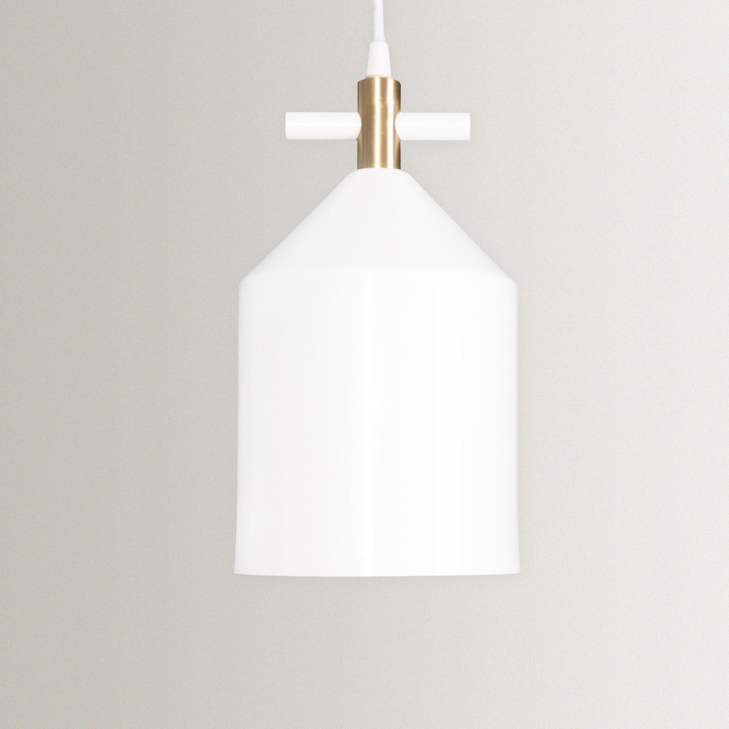 White bell pendant lamp in brass by Hatsu
Dimensions: W 15 x H 27 cm 
Materials: Powdercoated aluminium, brass fabric cord

Hatsu is a design studio based in Mumbai that creates modern lighting that are unique and immediately recognisable. We