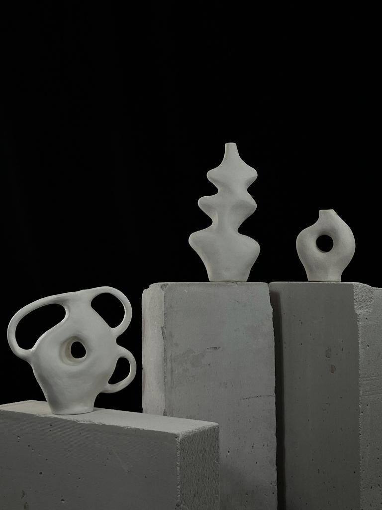 Large White Biomorphic Ceramic 3-Handle Vessel by Hanna Englund Ceramics. Designed to stand alone as a sculptural center piece or as a functional vase for minimal floral arrangements.
Materials: Ceramics. White stoneware with a layer of liquid