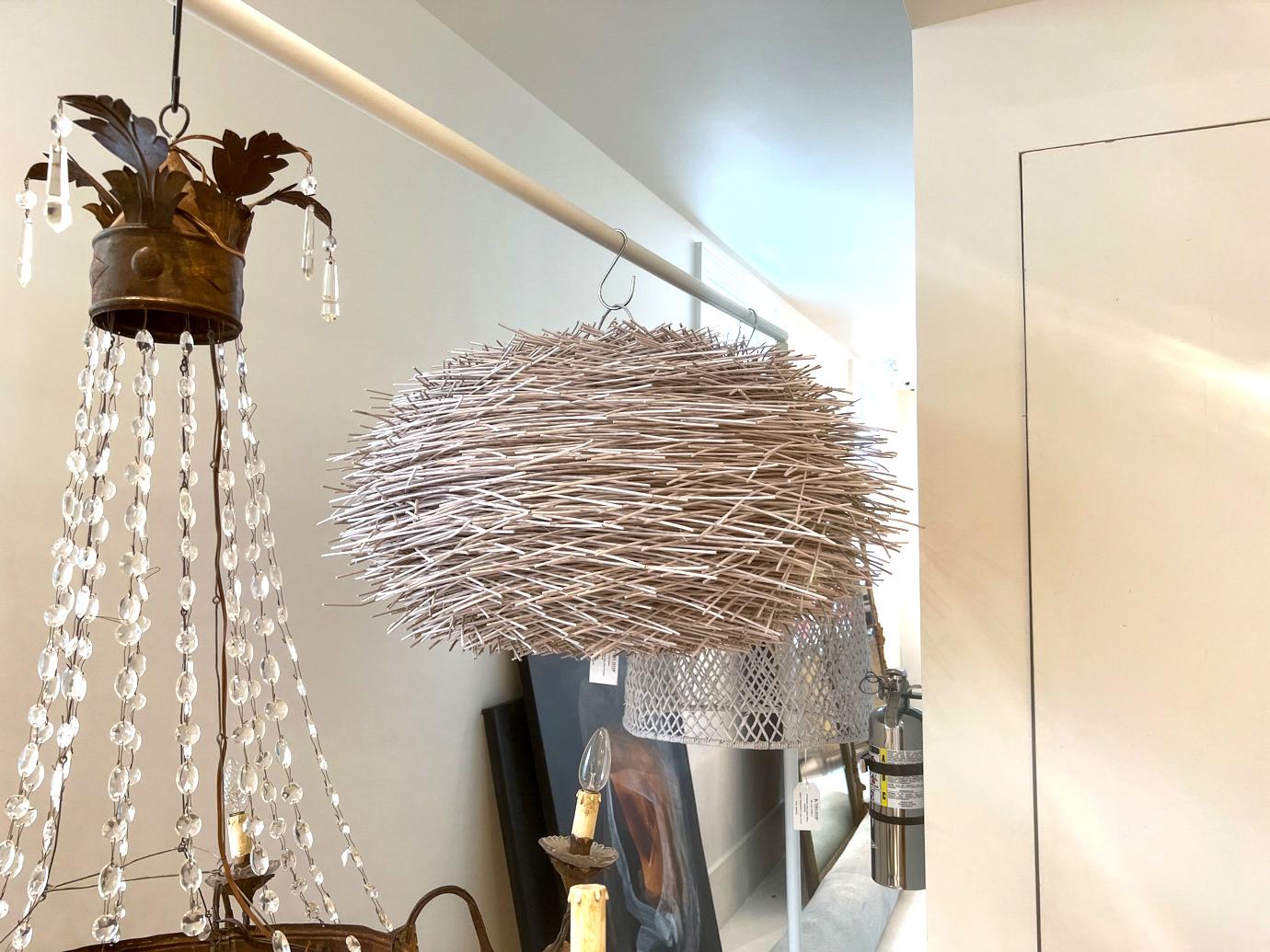 A light fixture with understated audacity. It resembles a large bird's nest of white reeds. This is the shade only. A pendant light fixture would hang inside.
