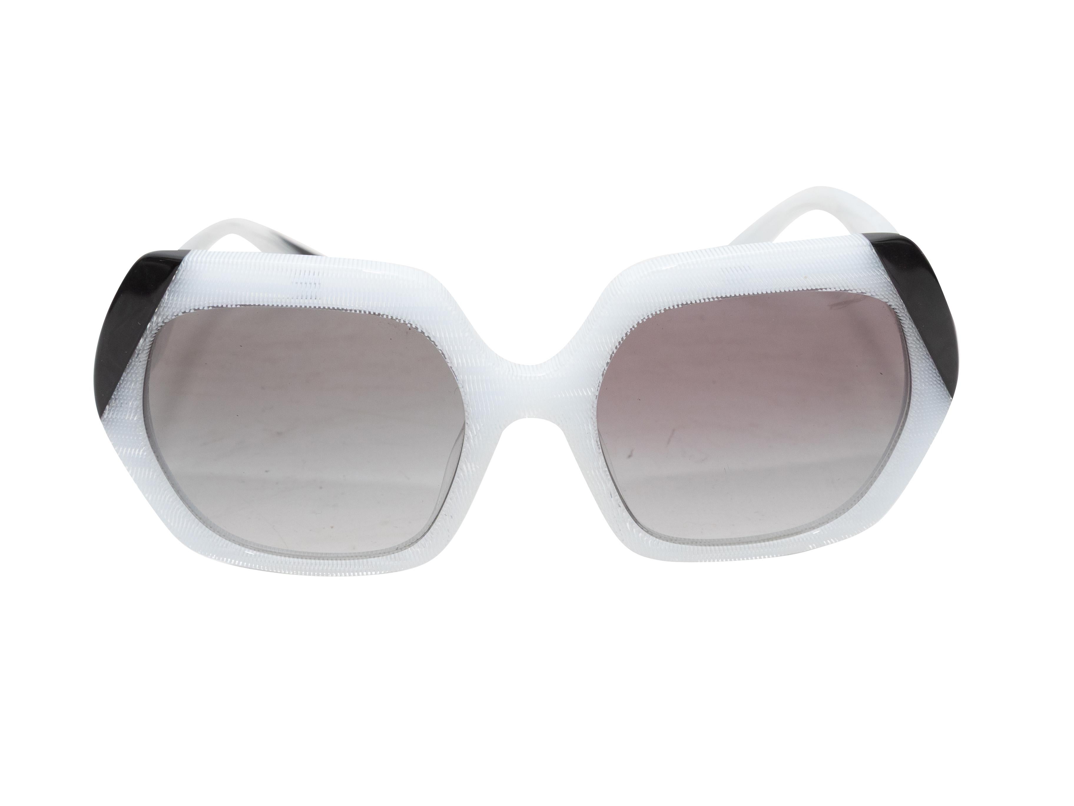 White and black acetate oversized sunglasses by Alain Mikli. Grey tinted lenses. 0.8