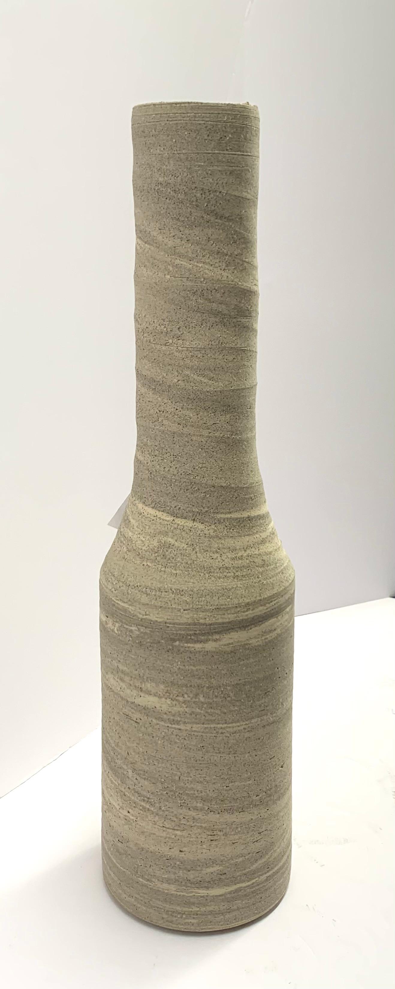 Contemporary German handmade stoneware vase.
Tall, thin funnel neck opening.
White, black and sand color stoneware.
Part of a large collection of handmade vases of different sizes , shapes and textures.