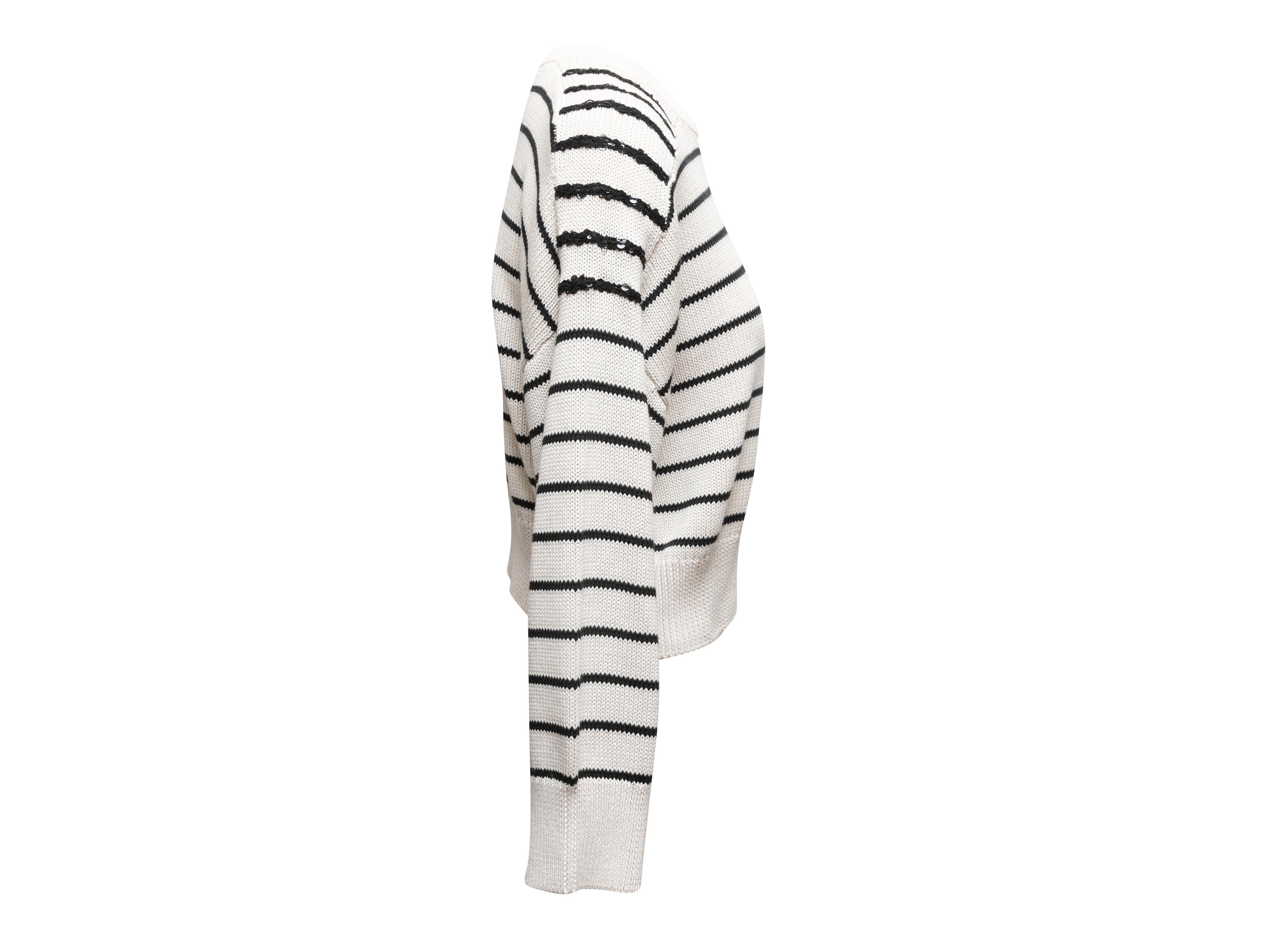 White and black striped knit sweater by Brunello Cucinelli. Crew neck. Sequin embellishments at shoulders. 42