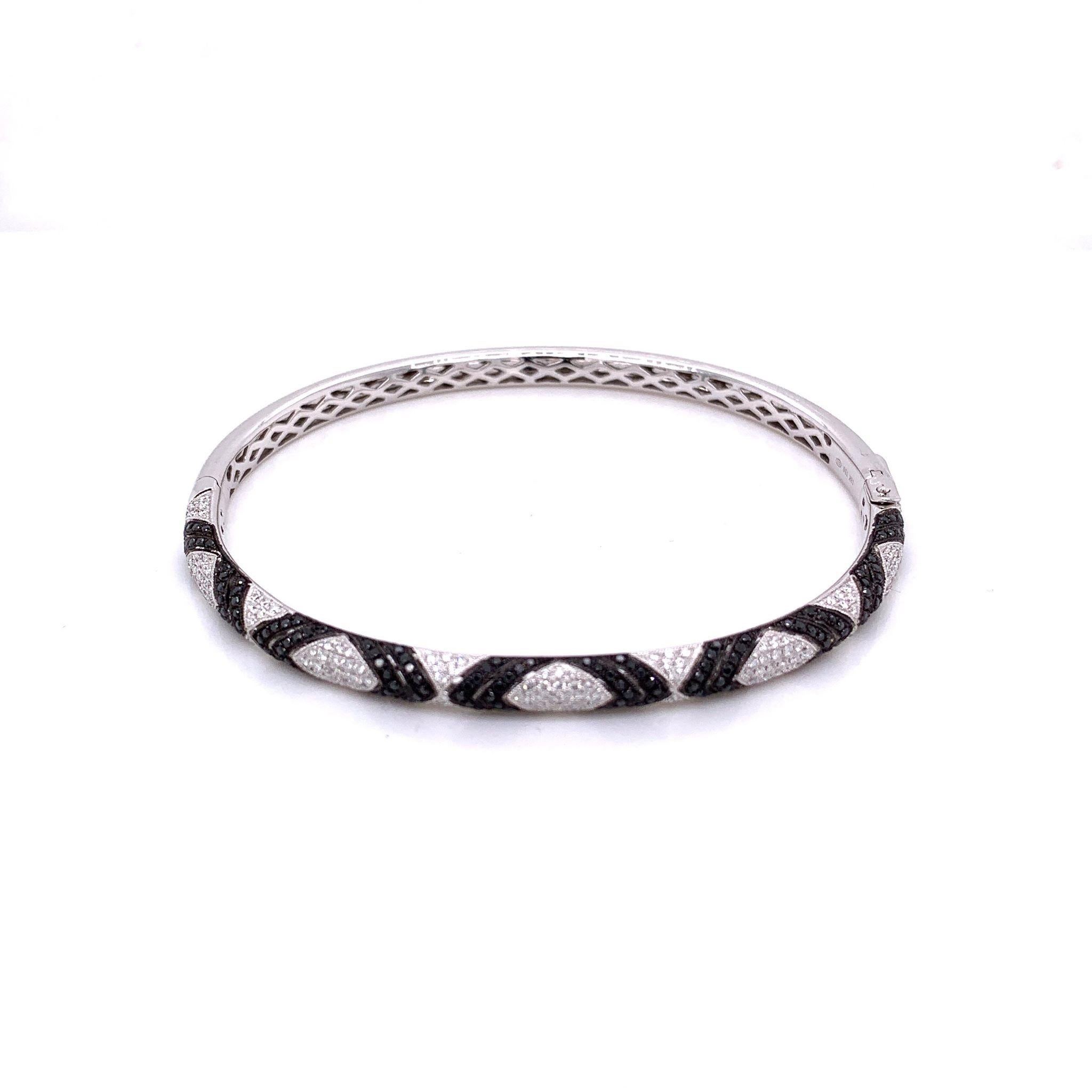 A lovely bracelet that can we worn every day. This piece features 0.66 carats of round cut white diamonds along with 0.60 carats of black diamonds. The light and dark colored diamonds add great contrast and made a pattern in their placement. Set in