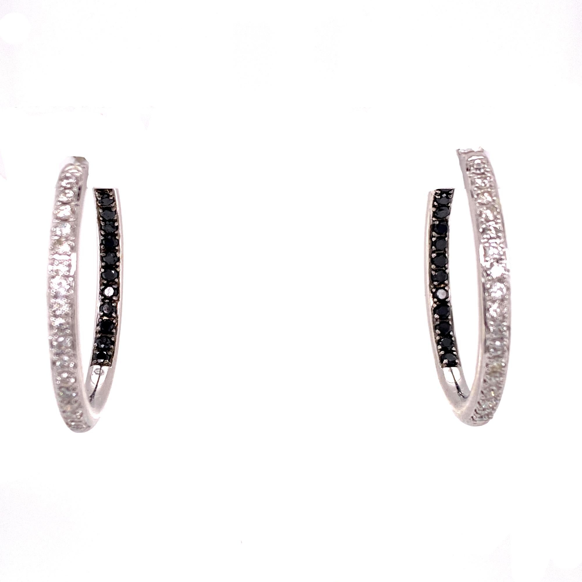 Great everyday light diamond hoop earrings. The in and out hoops feature round brilliant cut white diamonds on the front side and round brilliant cut black diamonds on the inside back for a total of 1.20 carat total weight. The in/out feature allows