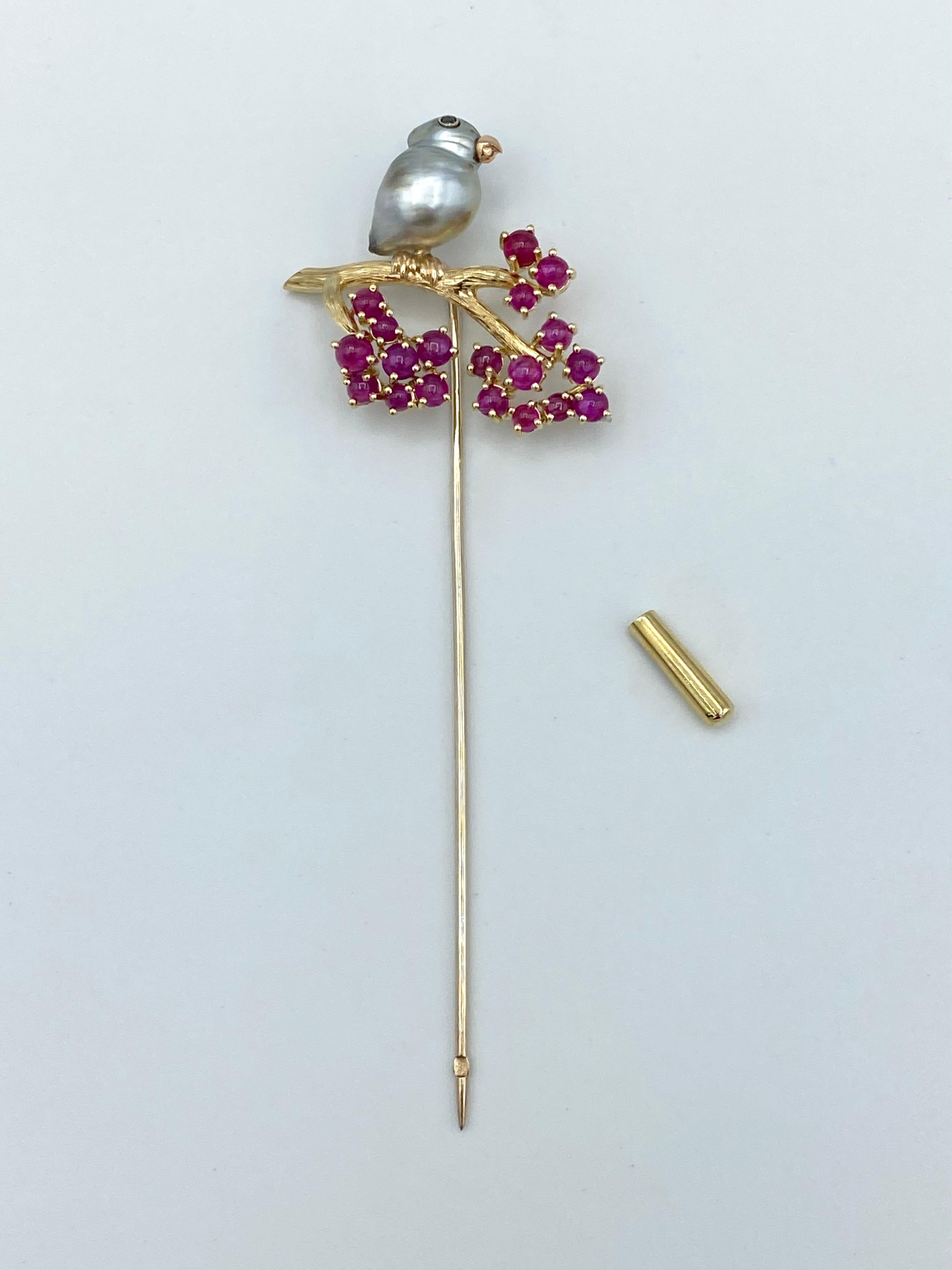 White Black Diamond Ruby Pin Stick Brooch 18Kt Gold Keshi Tahitian Pearl
This brooch is a hand engraved yellow gold branch and has 19 cabochon rubies which like red winter berries color and adorn its ends.
At the beginning of the branch is a white