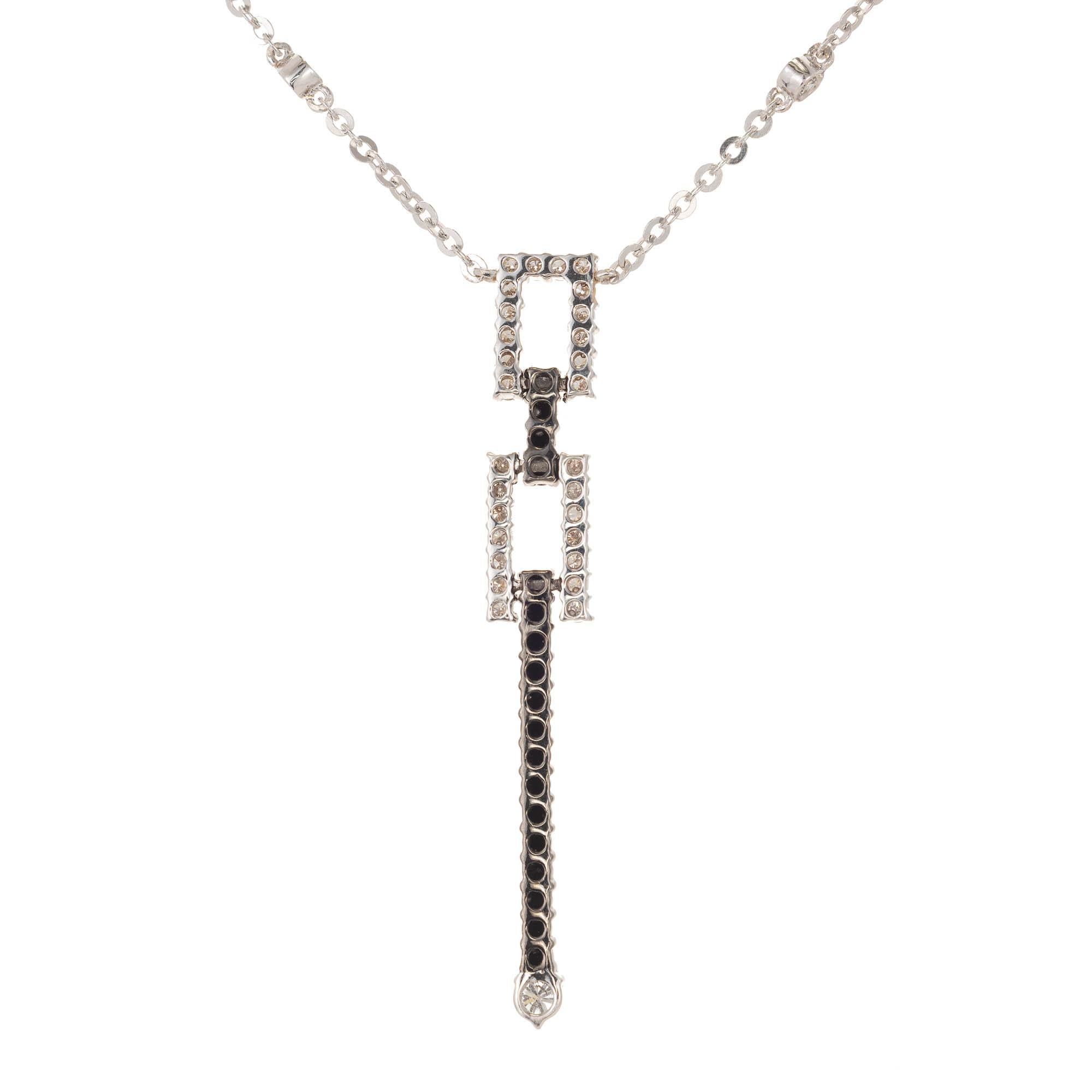 18k White gold black and white diamond pendant drop necklace. A 14k white gold flat link chain suspends a white and black diamond pendant at its center. Pendant of two rectangles set with white round diamonds connected by a vertical short row of
