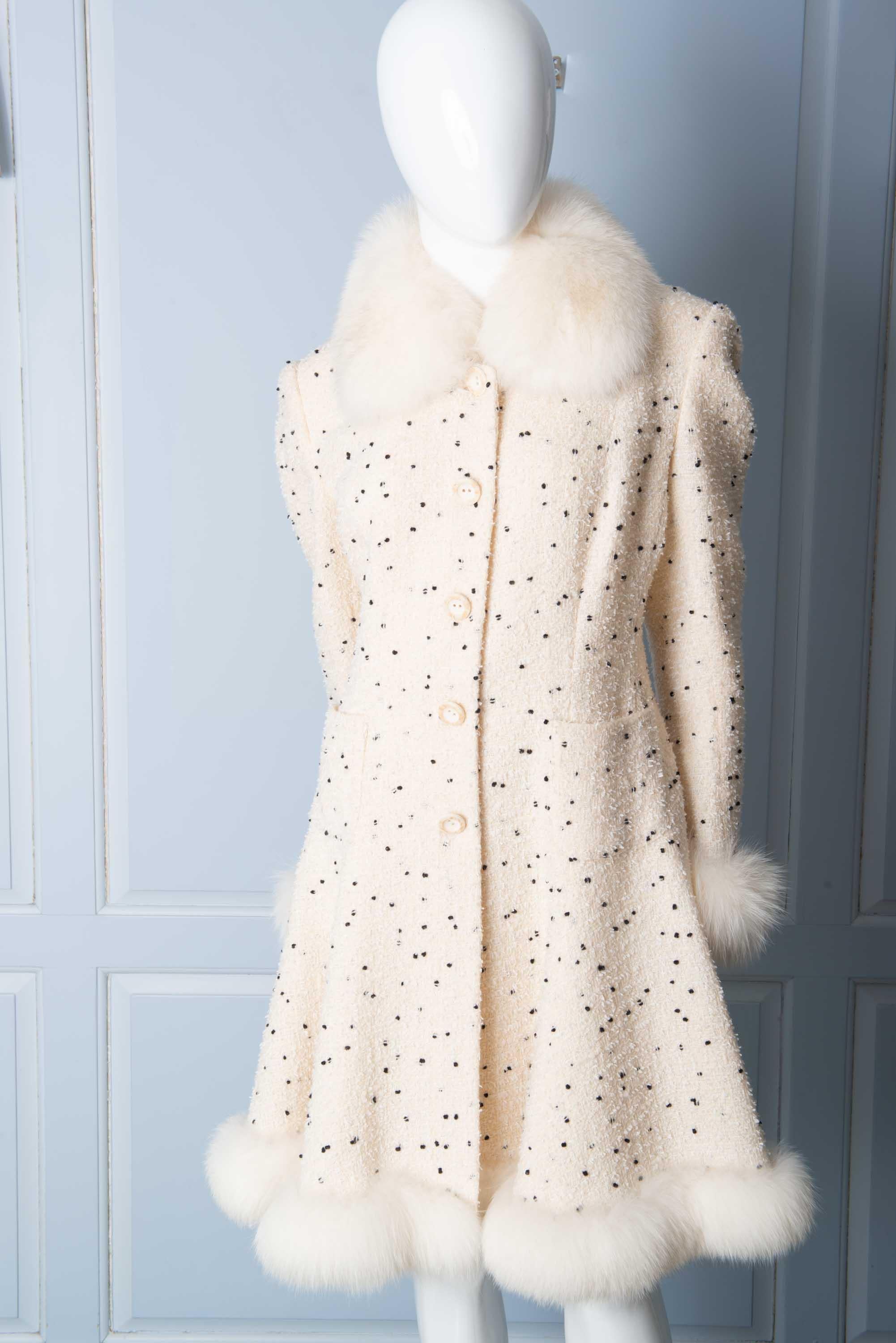 White boucle, black fleck Parisian coat with white fox fur collar, cuffs, and hem. Full lined. Fitted waist and full skirt. Annie Corvall, Rue St. Honore, Paris.