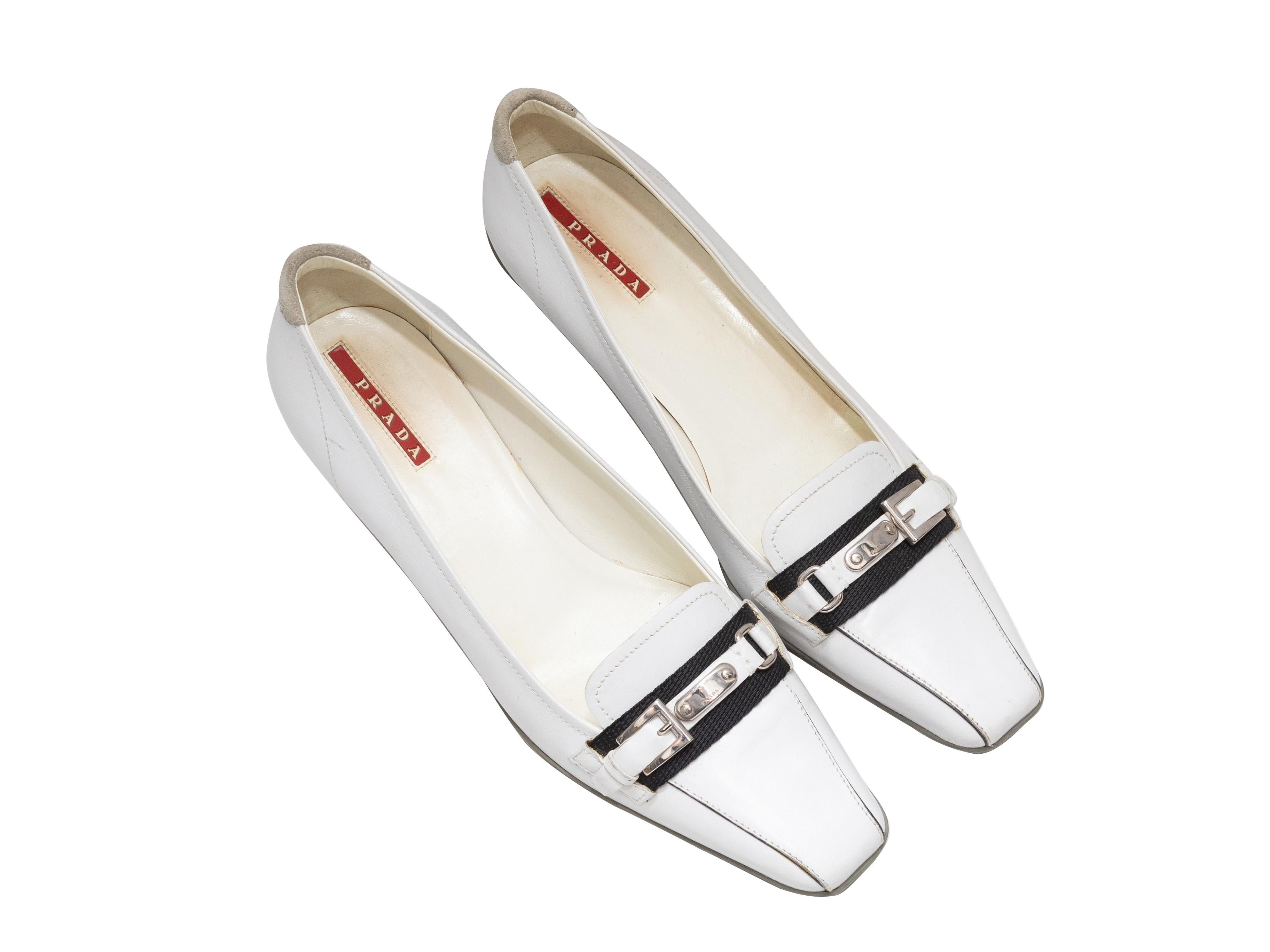 White and black patent square-toe kitten heels by Prada Sport. Silver-tone buckle accents at tops. 1.75