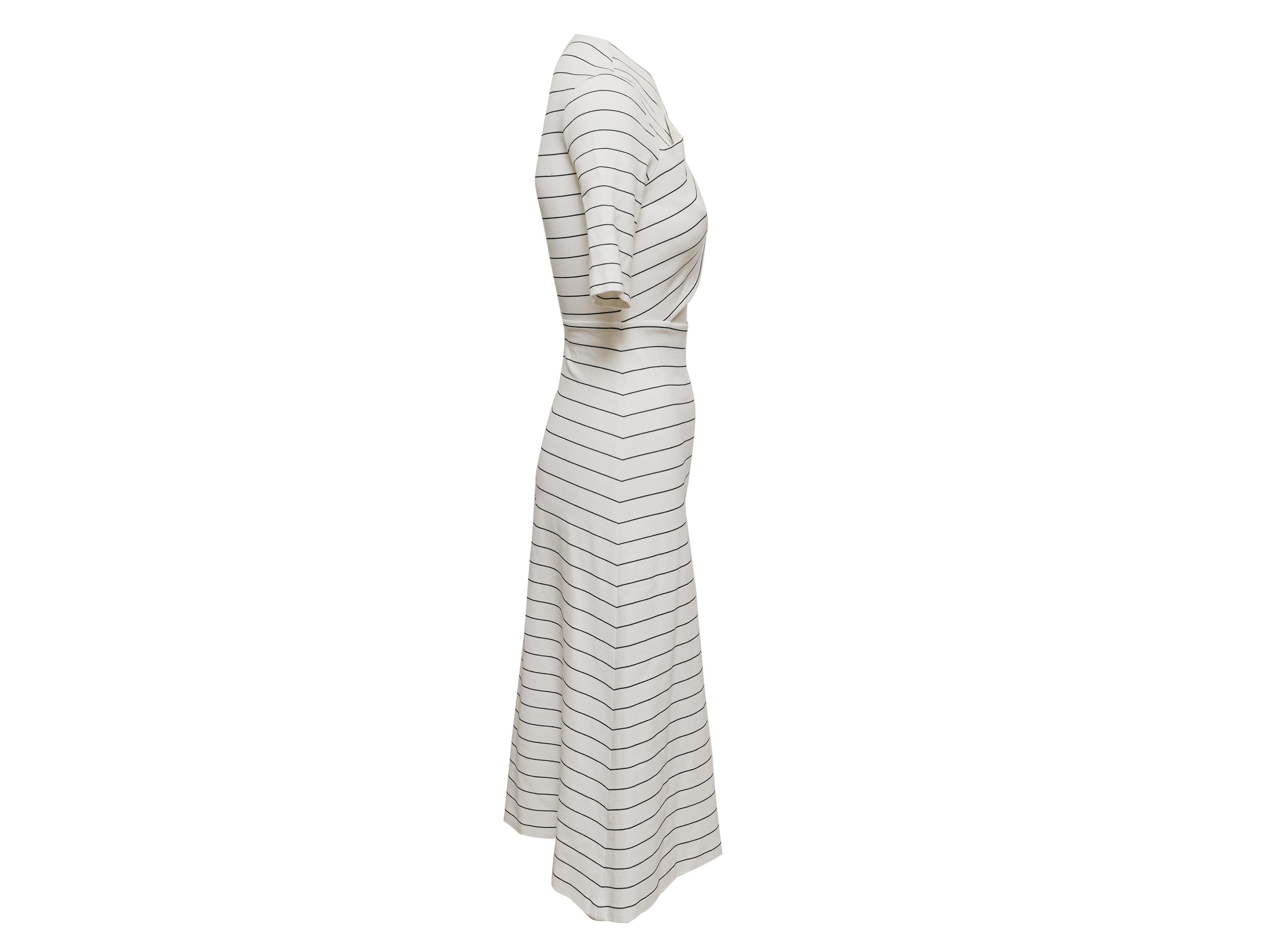 Product Details: White and black striped dress by Rosetta Getty. V-neck. Short sleeves. Zip closure at back. 30