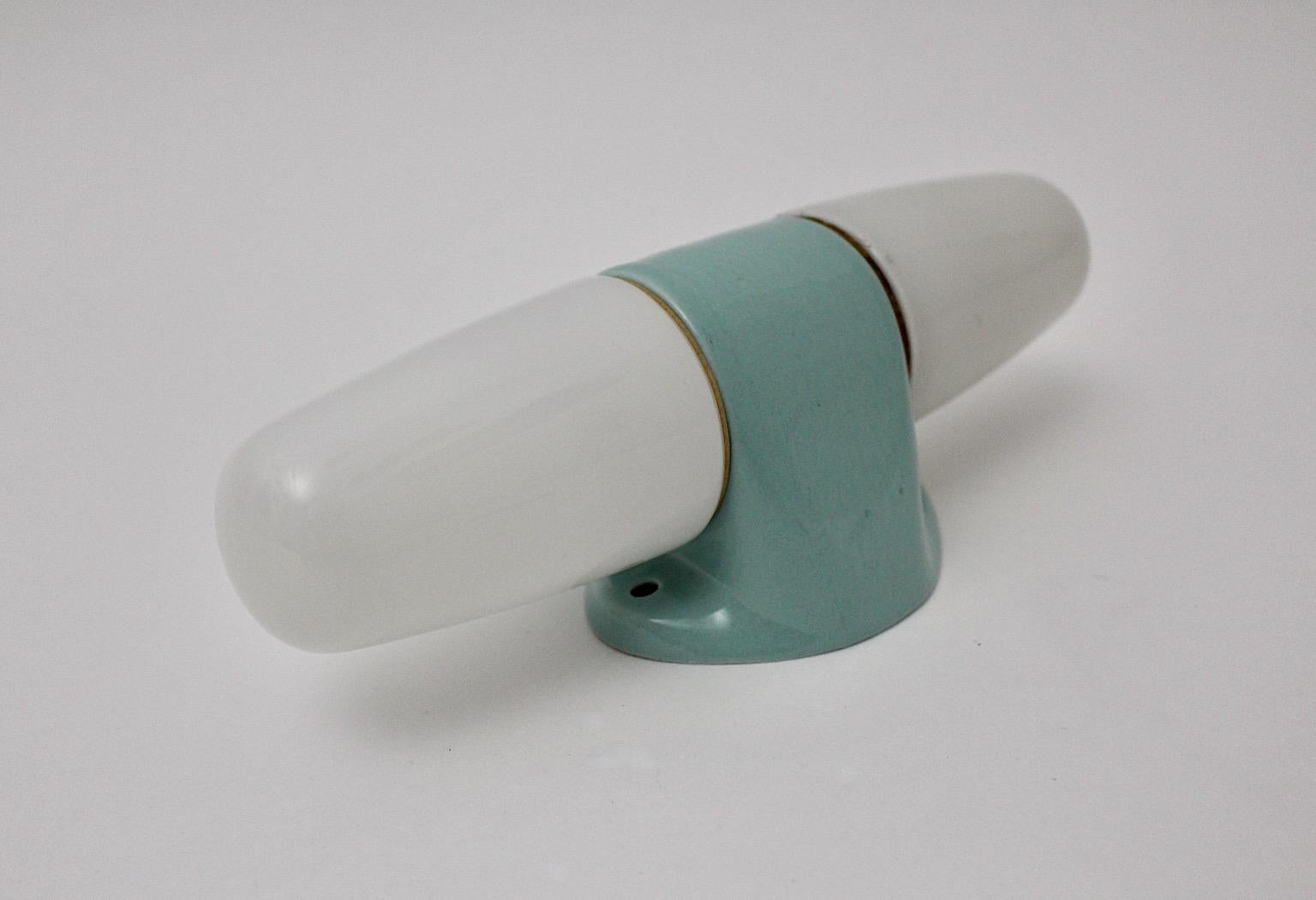 Mid-Century Modern sconce or wall light by Wilhelm Wagenfeld for Lindner Keramik 1950s Germany.
Sconce or wall light from white milky glass and pastel blue ceramic with two E 14 sockets.
Wilhelm Wagenfeld studied with the important teachers Laszlo