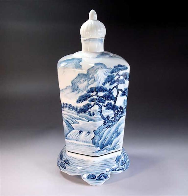Exquisite contemporary Japanese porcelain decorative three-piece raised lidded jar/vase, hand painted in auspicious underglaze blue and white , depicting scenes from Japan's countryside , a signed work by widely acclaimed Japanese master porcelain