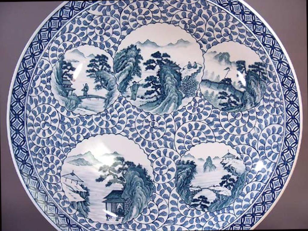 Exceptional large contemporary Japanese porcelain decorative charger, extremely intricately hand painted in auspicious underglaze blue and white , depicting scenes from Japan's countryside , a signed masterpiece by widely acclaimed Japanese master