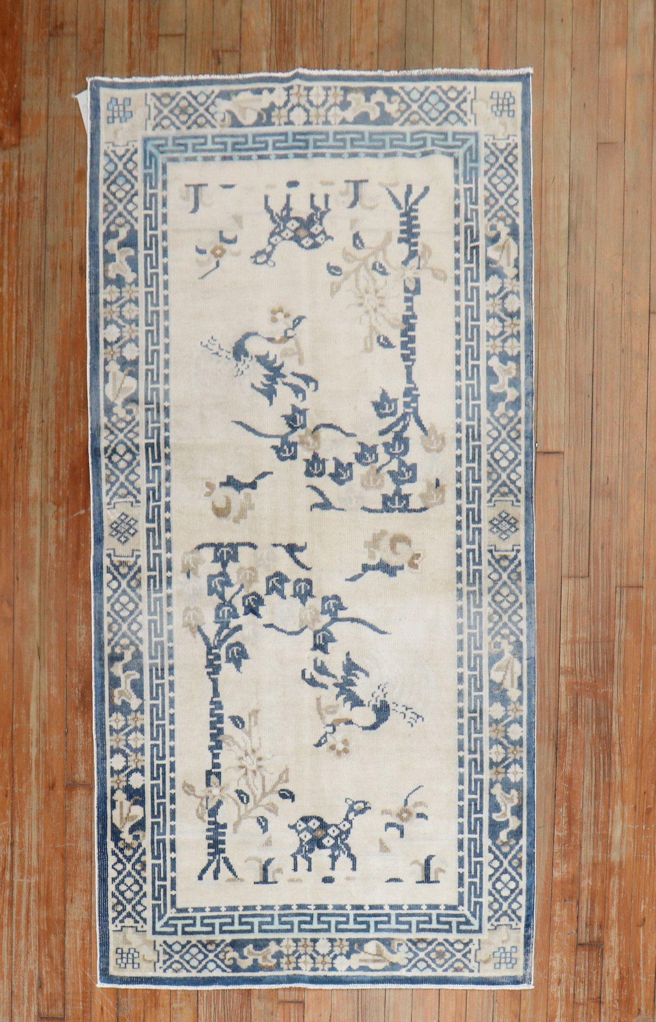 A mid20th-century Chinese Peking carpet with an animal motif in white and blue

circa 1950, measures: 3'1' x 5'8