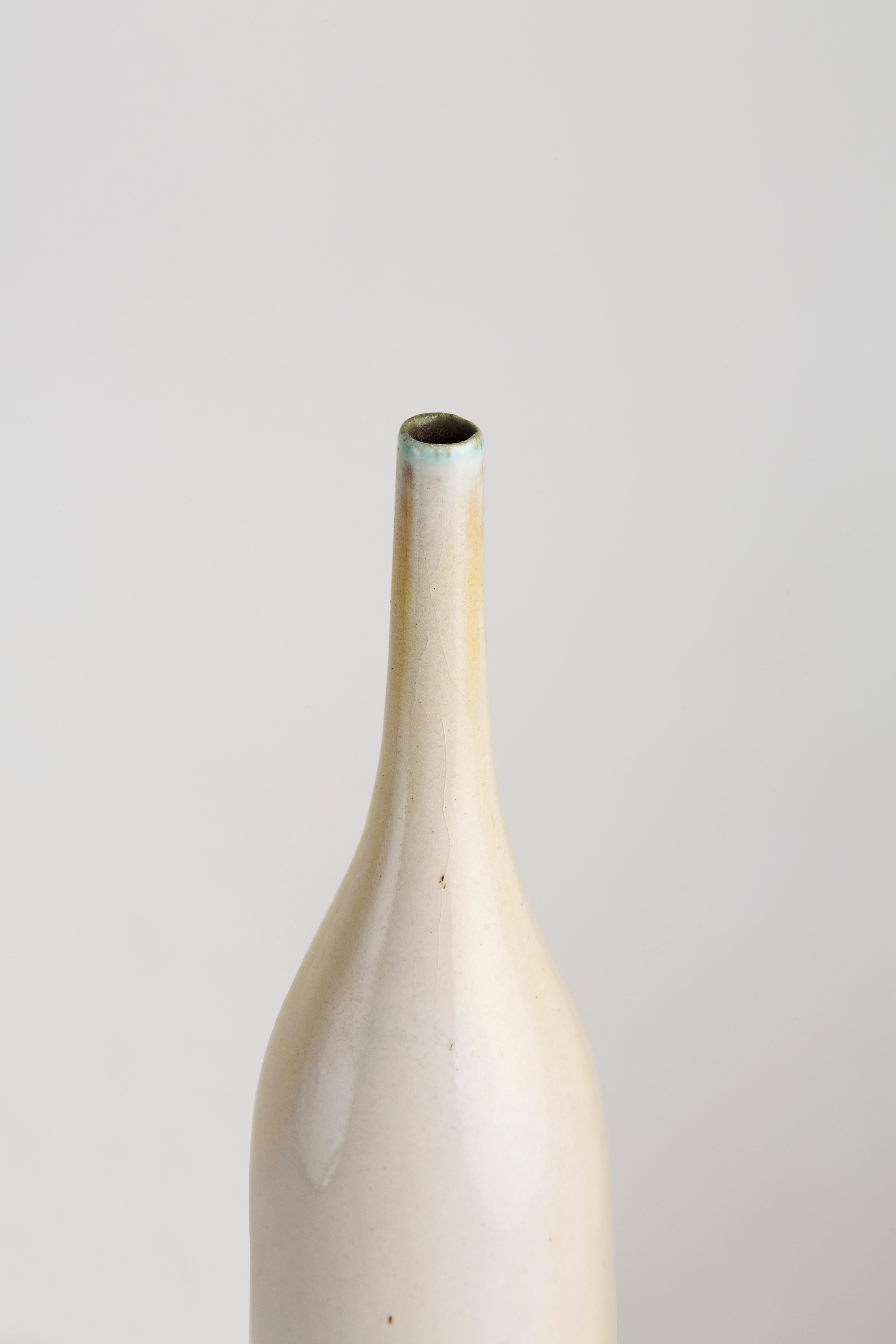 A bottle by the french ceramist Georges Jouve (1910-1964), in white glazed stoneware, underside incised with artist’s signature and his characteristic alpha cipher, circa 1955