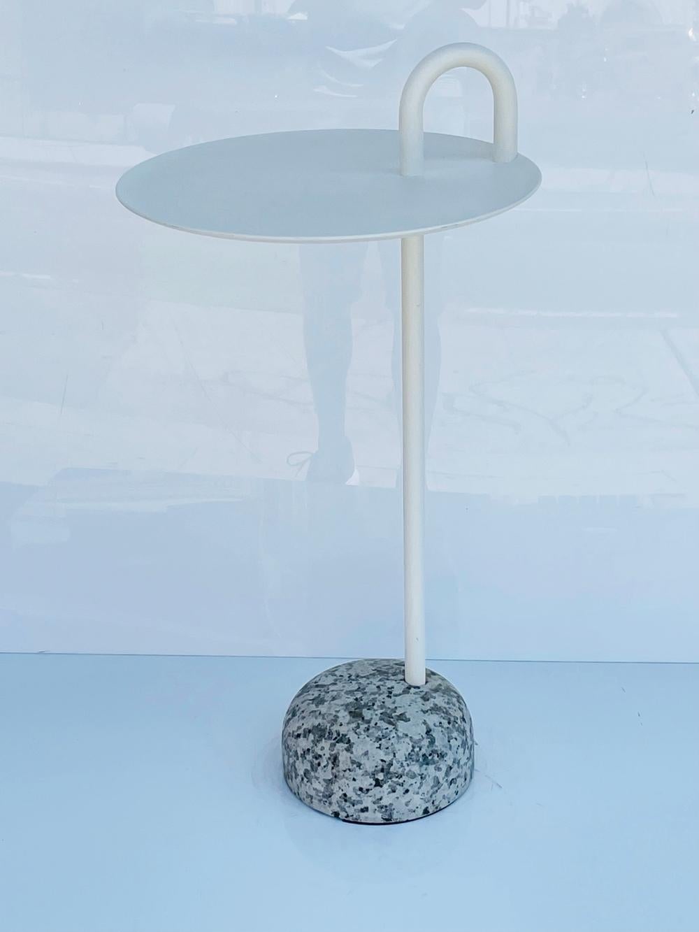 Bowler is a compact side table designed for small spaces.

Its single tube support extends upwards from its solid granite base to create a defined profile and a clever, functional semicircular handle.

The stem, handle, and tray are made from