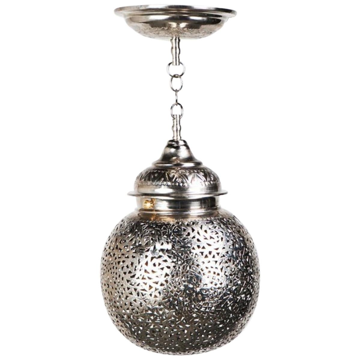 The pair of ball-shaped pendants or chandeliers are painstakingly created in the workshop of master artisans and features Fine white brass and intricate hand-tooled filigree work. This light-emitting orb produces a diffuse, filtered light, creating
