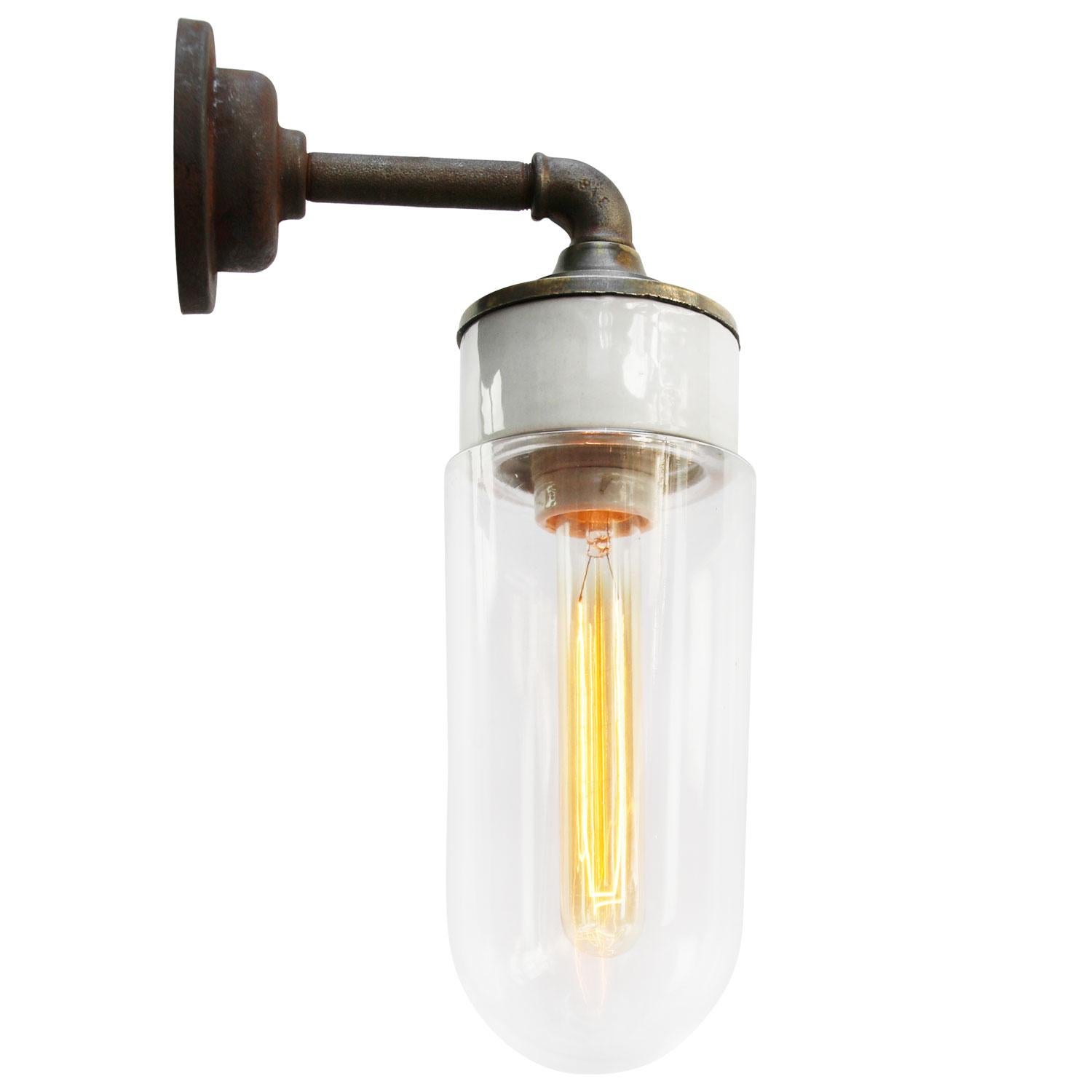 Porcelain Industrial wall lamp.
White porcelain, brass and cast iron
Clear glass.
2 conductors, no ground.

Diameter cast iron wall piece 10.5 cm / 4”.
2 holes to secure.

Weight: 2.10 kg / 4.6 lb

Priced per individual item. All lamps have been