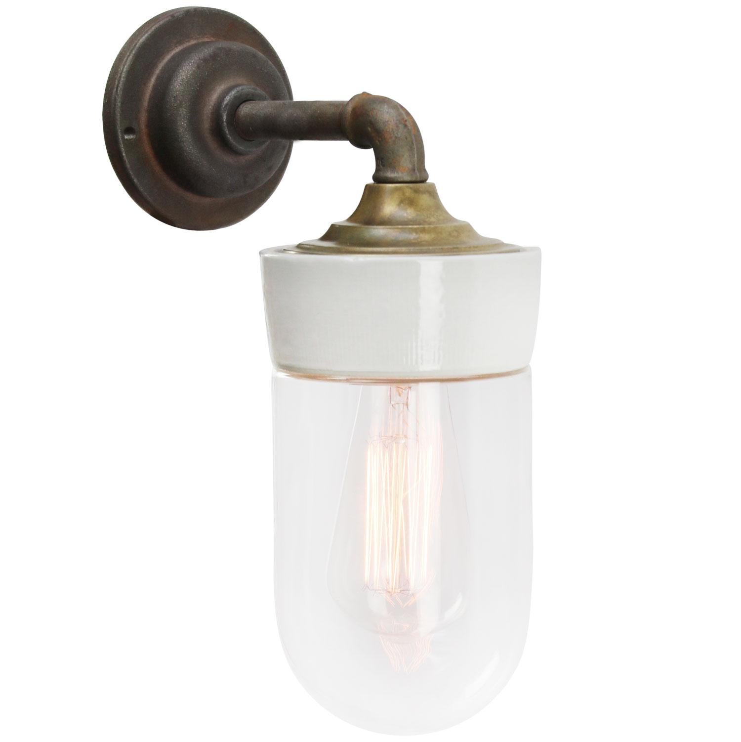 Porcelain Industrial wall lamp.
White porcelain, brass and cast iron
Clear glass.
2 conductors, no ground.

Diameter cast iron wall piece 10 cm. 2 holes to secure.

Weight: 2.25 kg / 5 lb

Priced per individual item. All lamps have been