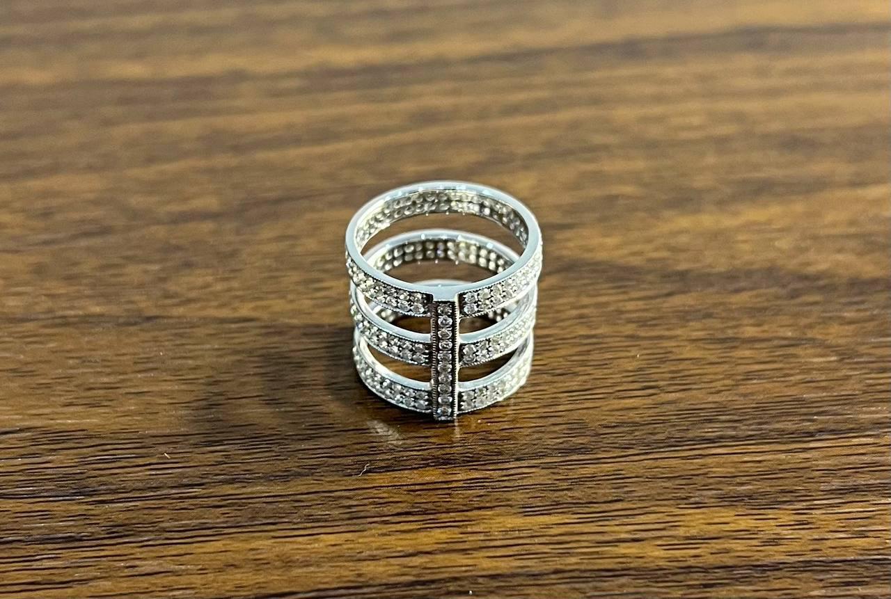 Elegant Modern Silver Multi-Band Ring. This striking ring features a contemporary design with multiple bands adorned with sparkling stones. The bands are connected by vertical bars, creating an open, airy structure. The ring's intricate detailing