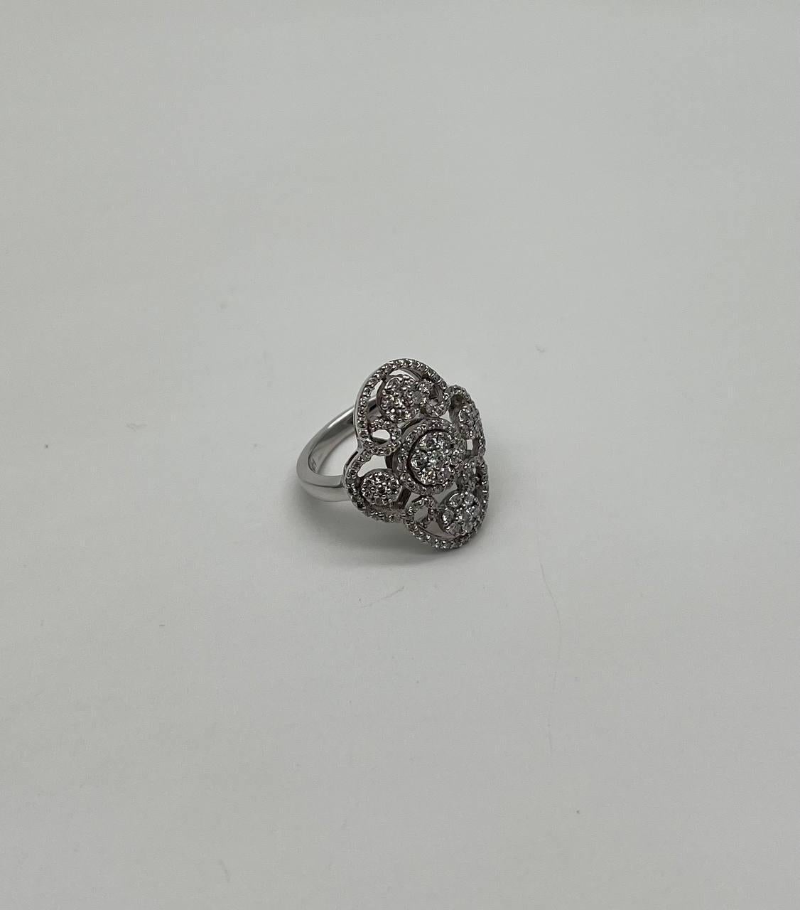 This elegant ring is crafted with symbolism in mind. It features a stunning arrangement of round diamonds set in a unique, intricate design. The diamonds are meticulously placed to form a symmetrical pattern, creating a captivating visual effect.