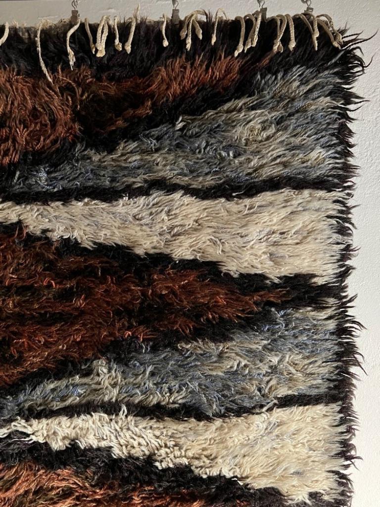 Vintage small high pile wool rug in gray-black-white-blue-brown hues.

Additional information:
Country of manufacture: Sweden
Period: 1960s
Dimensions: 72 W x 127 D cm
Condition: Good vintage condition, partly missed fringe - check the back side