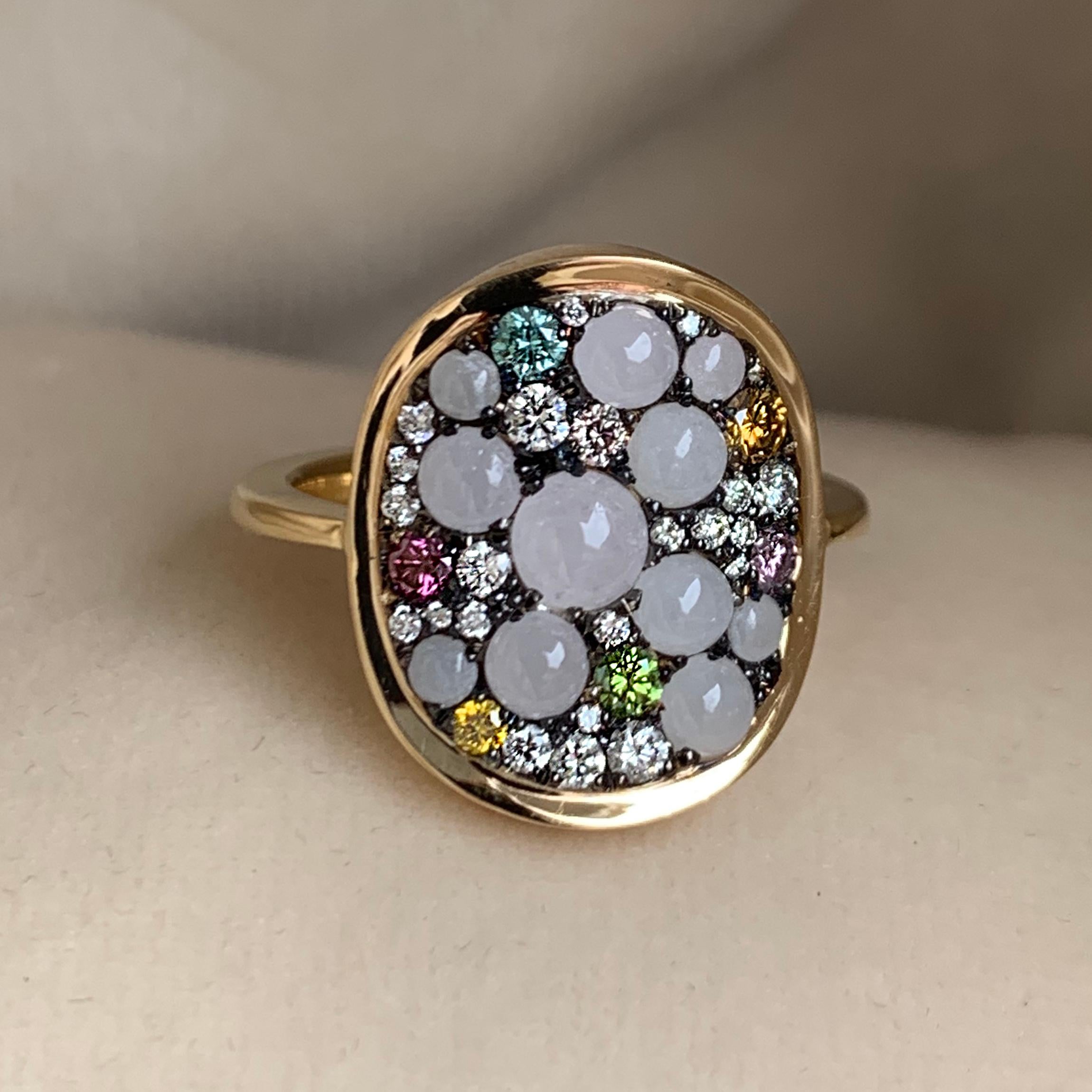 One of a kind ring with the fire and sparkle of diamonds and the lovely soft touch of white Burmese Jadeite:

Made in 18K yellow gold 5,5 g & blackened sterling silver 1,7 g (The stones are set on blackened silver to create a black background for