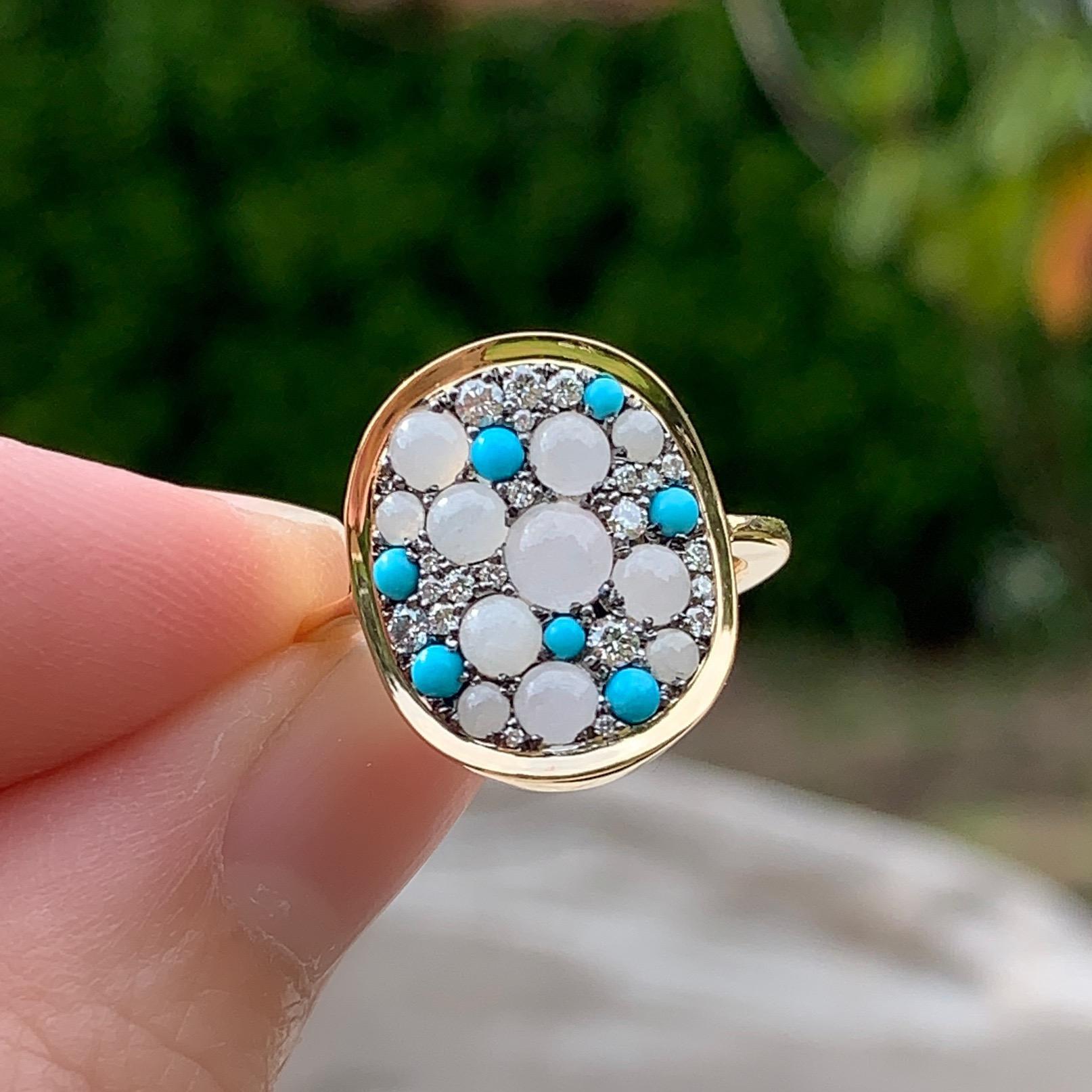 One of a kind ring in 18K yellow gold 5,5 g & blackened sterling silver (The stones are set on blackened silver to create a black background for the stones)
Pave set with A type White Translucent Burmese Jadeite cabochons, Turquoise cabochons, White