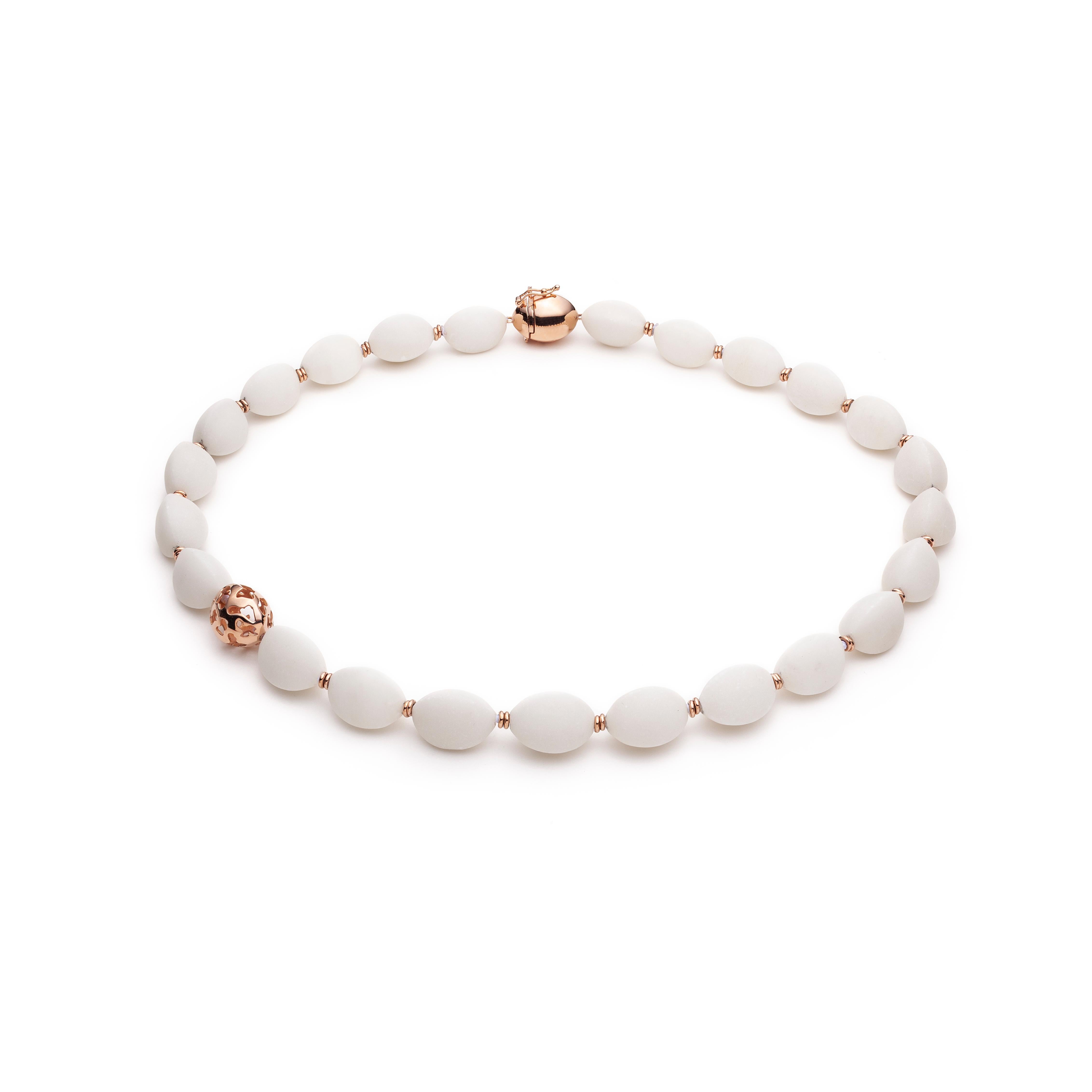 This unique, white calcite necklace is strung on silk and knotted for extra security, it adapts perfectly to the shape of your neck. Tiny gold elements hide the security knots. The 18k pink gold bead and the custom-made clasp, both replicate the
