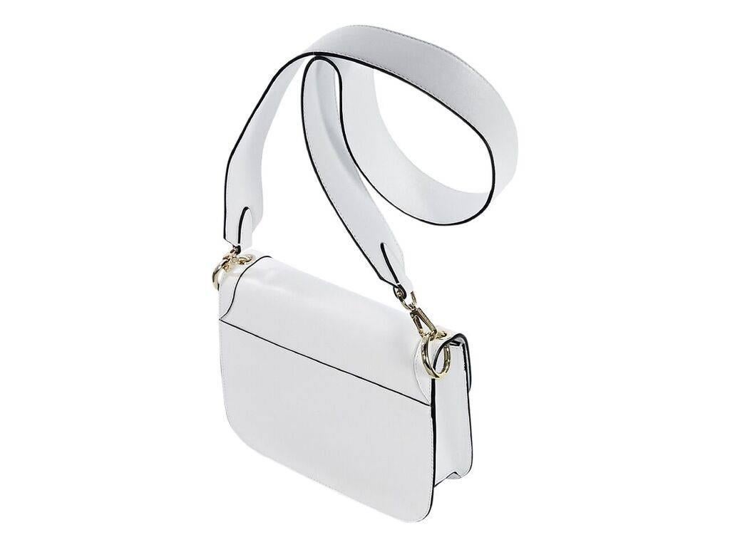 Product details:  White leather crossbody bag by Cambiaghi Milano.  Detachable crossbody strap.  Front flap with twist-lock closure.  Lined interior with inner zip pocket.  Goldtone hardware.  Dust bag included.  9.5