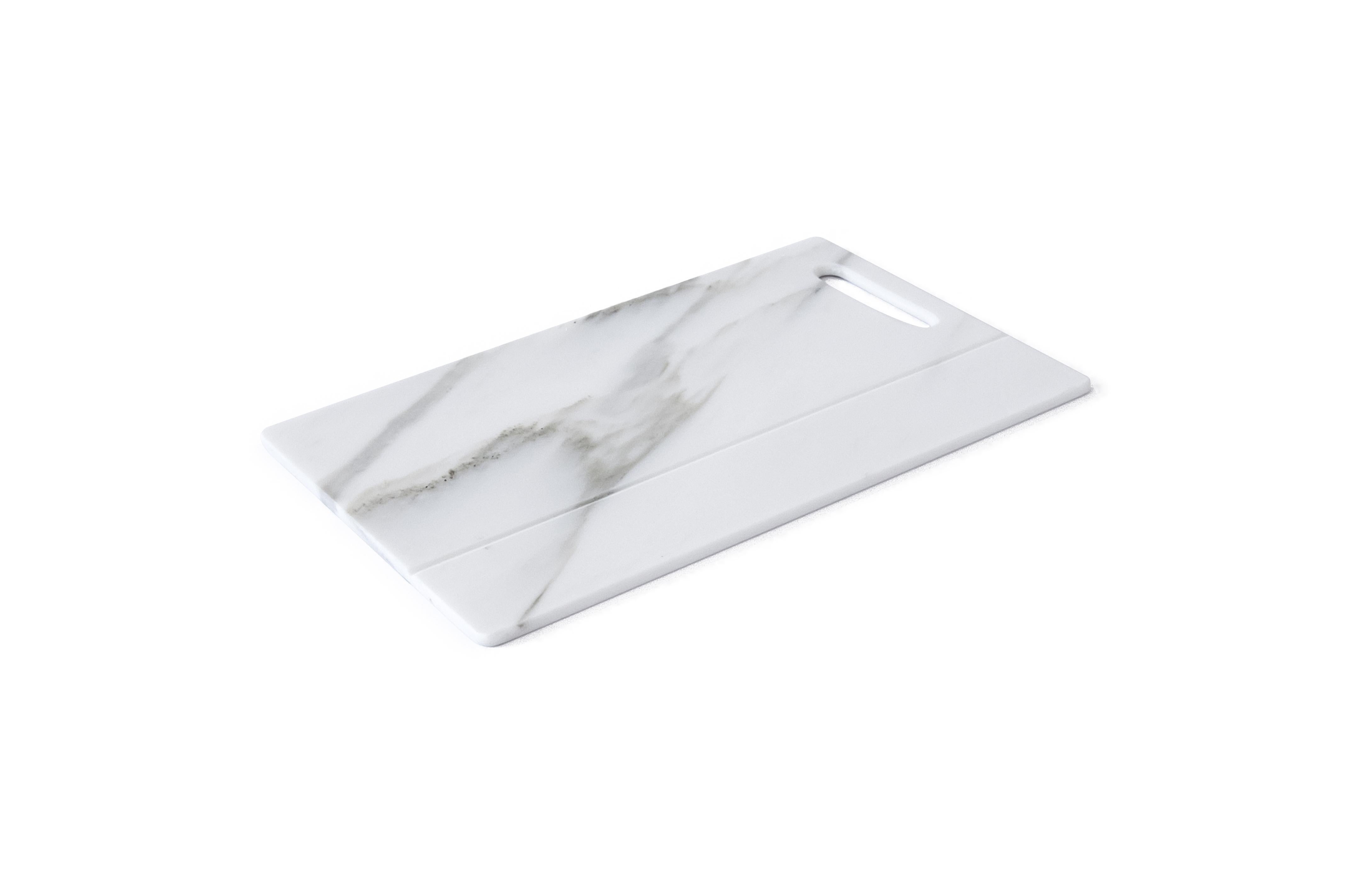 White Carrara marble asymmetric chopping board.

Each piece is in a way unique (every marble block is different in veins and shades) and handmade by Italian artisans specialized over generations in processing marble. Slight variations in shape,