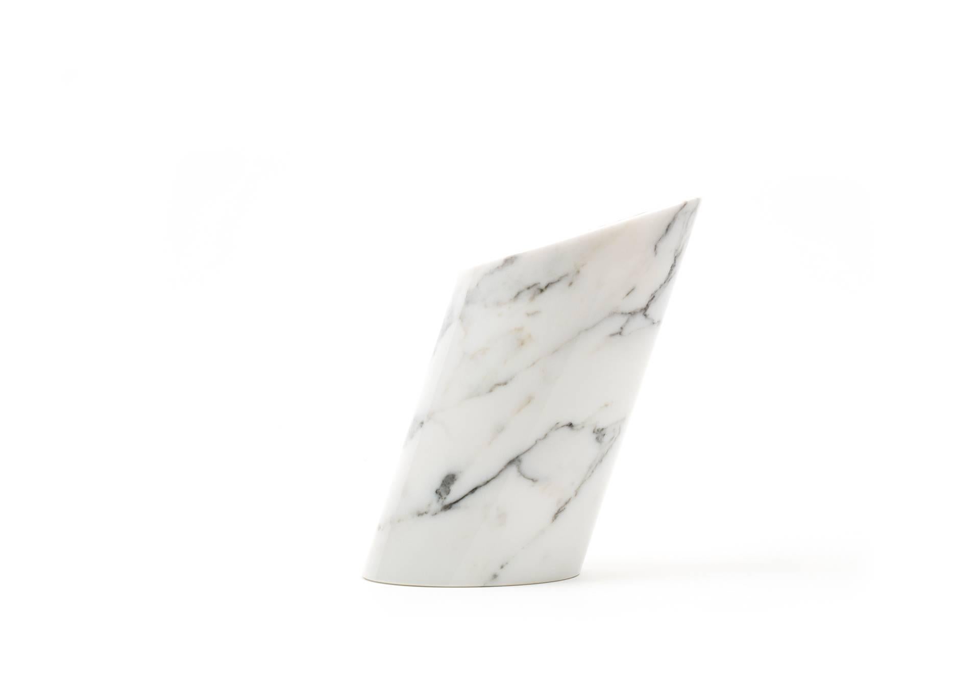 White Carrara marble bottle holder for wine bottles. Each piece is in a way unique (since each marble block is different in veins and shades) and handcrafted in Italy. Slight variations in shape, color and size are to be considered a guarantee of an