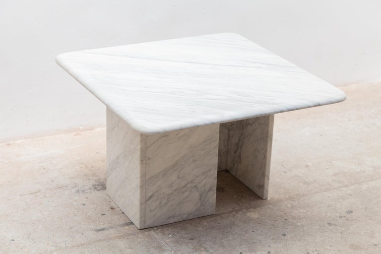 White carrara marble coffee table 1970 The table is in very good condition. The square rounded top rests on a two sided bases and can be placed in different positions.Dimensions: 70-70-43cm.