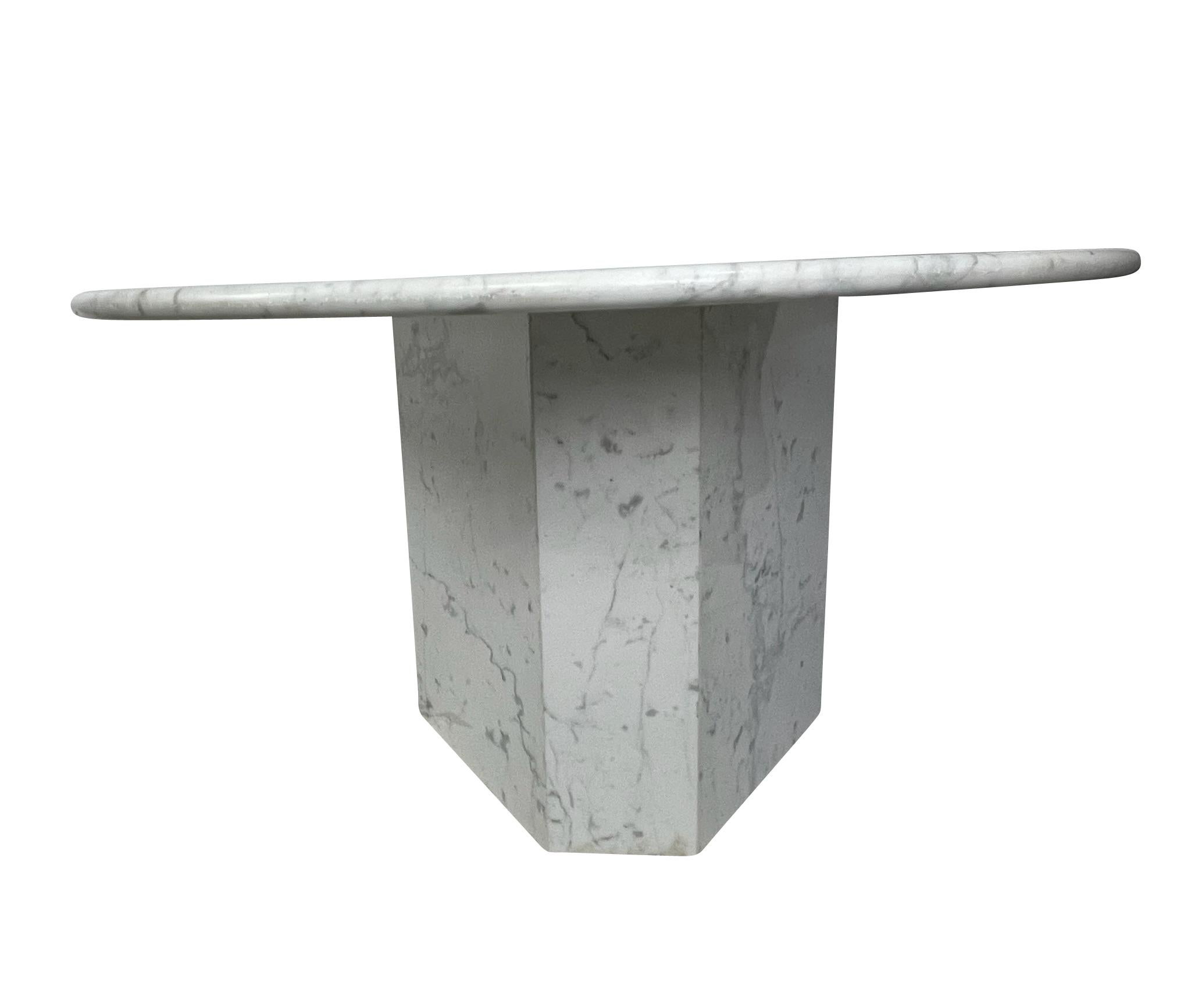 Very special solid white Carrara marble round dining, foyer, or kitchen table with a 3-sided polygon base.  This table was handcrafted from Carrara marble in Italy. Solid top and base and a sealed marble surface for dining and meals. This table