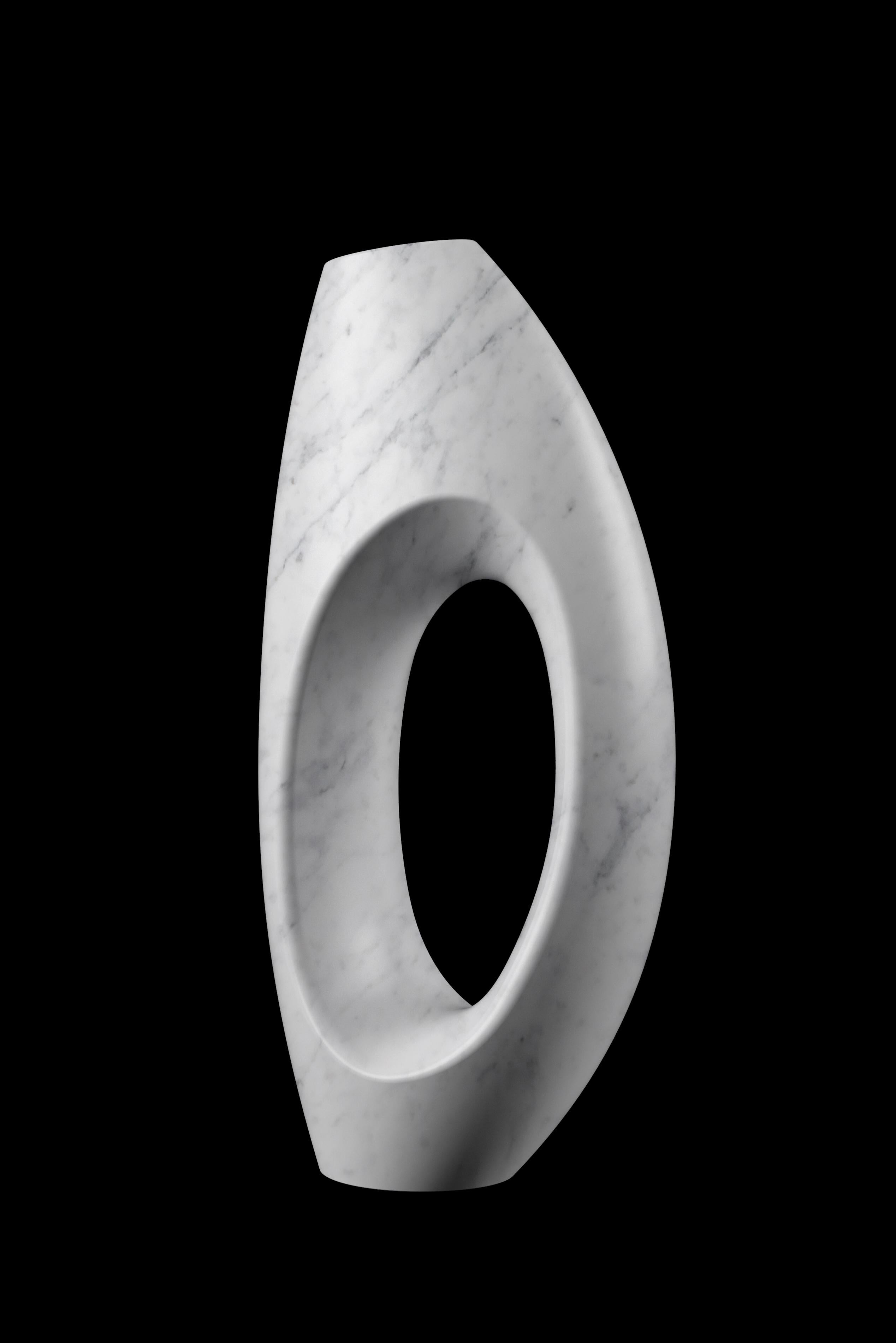 Sculptural vase carved by hand from a solid block of white Carrara marble, velvet finish. This vase reproduces, in a smaller version, the iconic sculptural vase PV02 designed by the Atelier Barberini & Gunnell, hand made in a limited edition for the