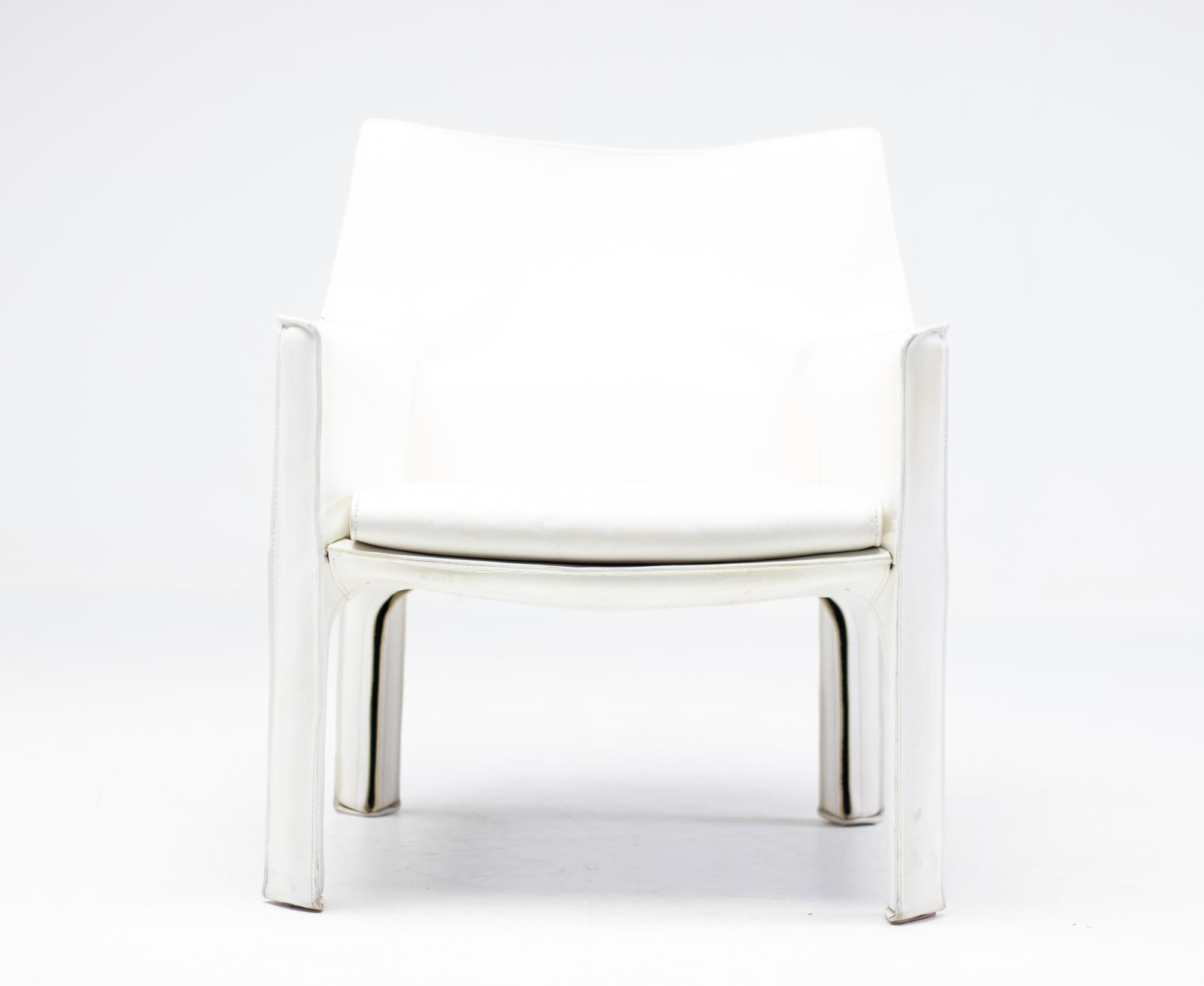 Early Mario Bellini Cab 414 arm chair with white saddle leather upholstery zippered over the steel frame.
Many years of careful use gave them that unmistakable vintage appearance of a pair of used white leather gloves.
Very comfortable chair that