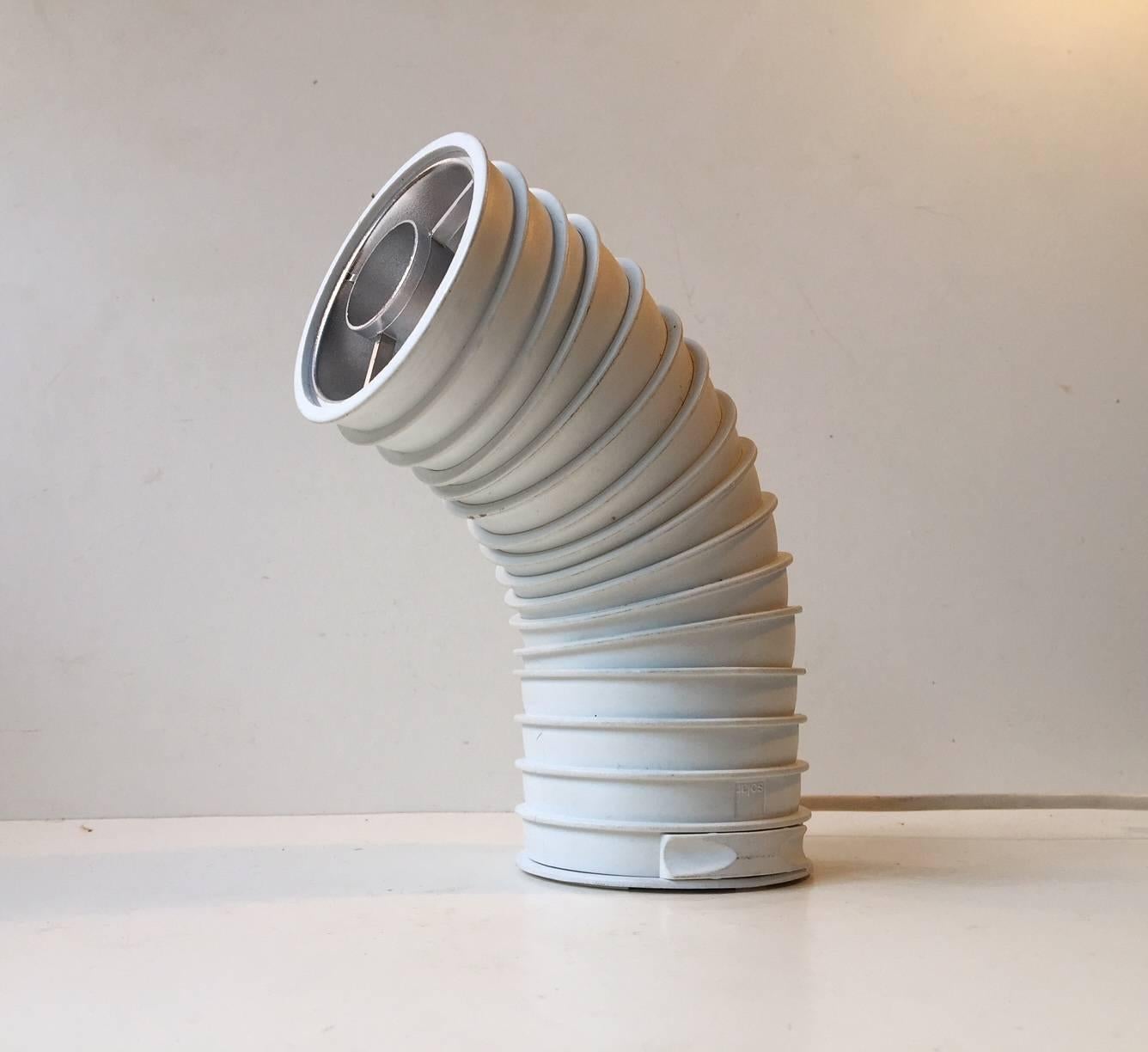 - Spage age table light
- Shaped like a worm or caterpillar or industrial pipe
- Designed by Danish architect Ole Pless-Jørgensen
- Manufactured by Nordisk Solar in Denmark in the 1980s
- Features a hidden switch on the bottom
- Halogen light