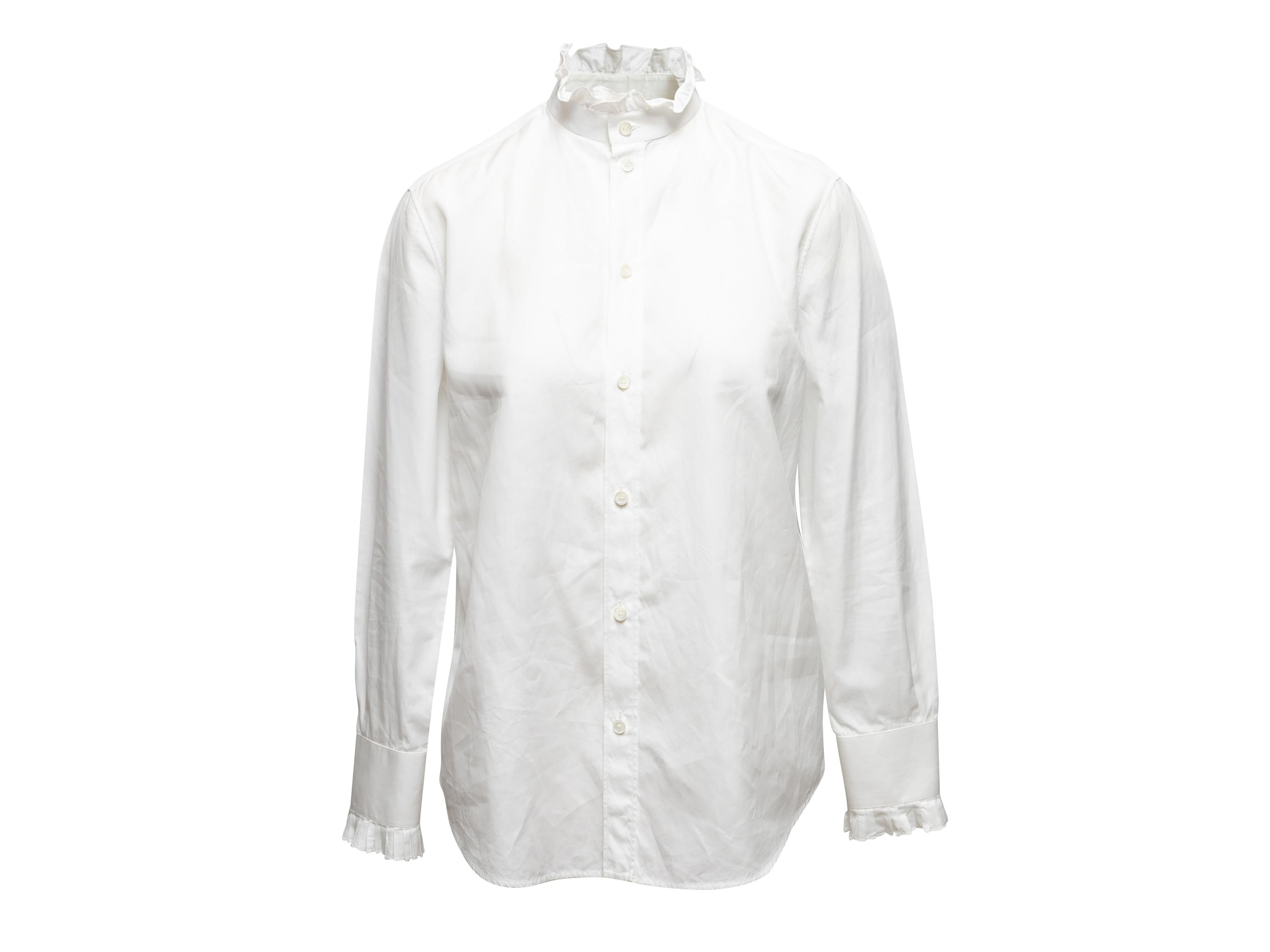 White long sleeve ruffle-trimmed button-up top by Celine. Stand collar. Button closures at center front. Designer size 40. V-neck. 30