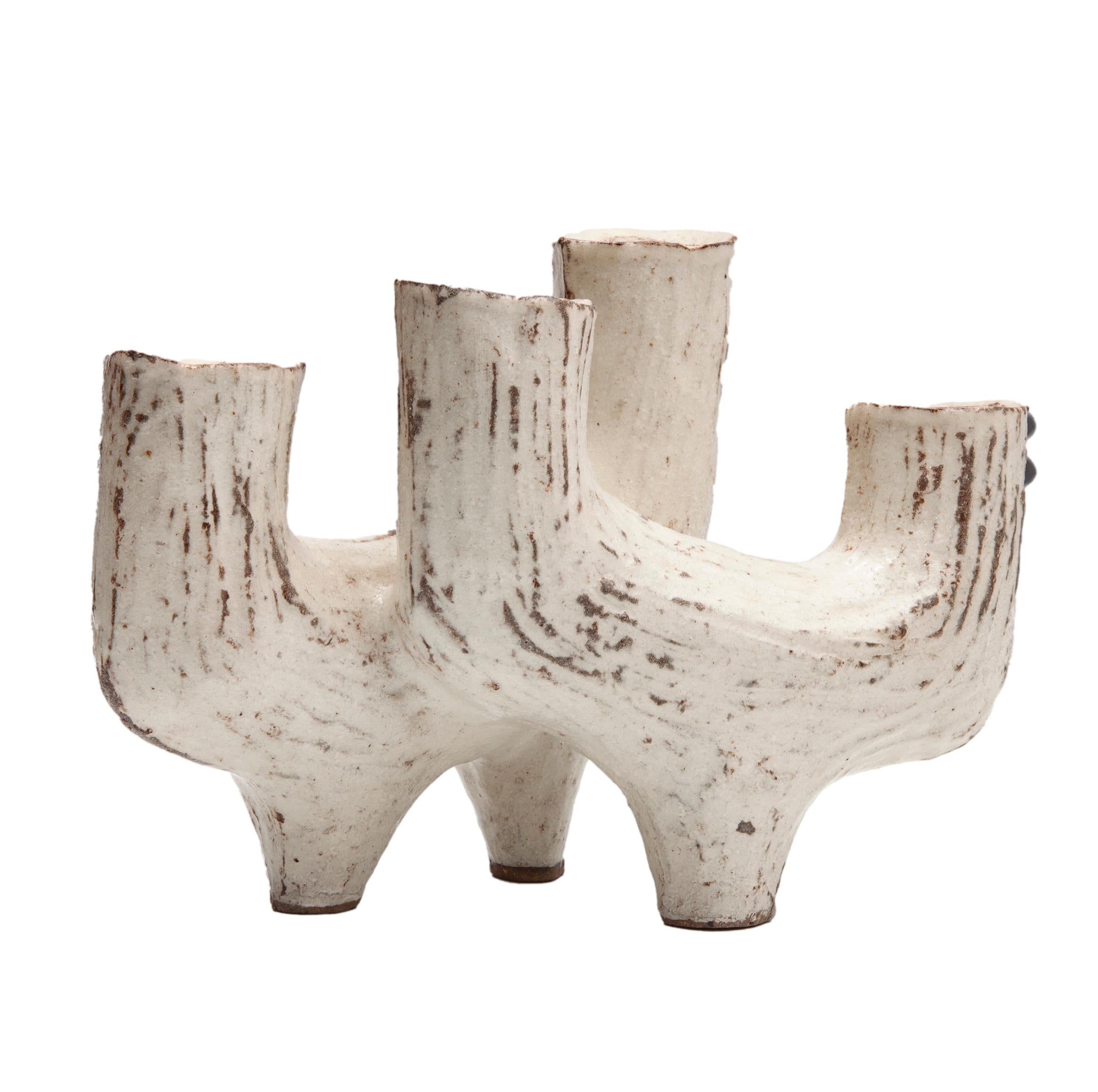 Mid century organic modern footed candleholder with 4 candleholders in oyster white with brown linear texture.
