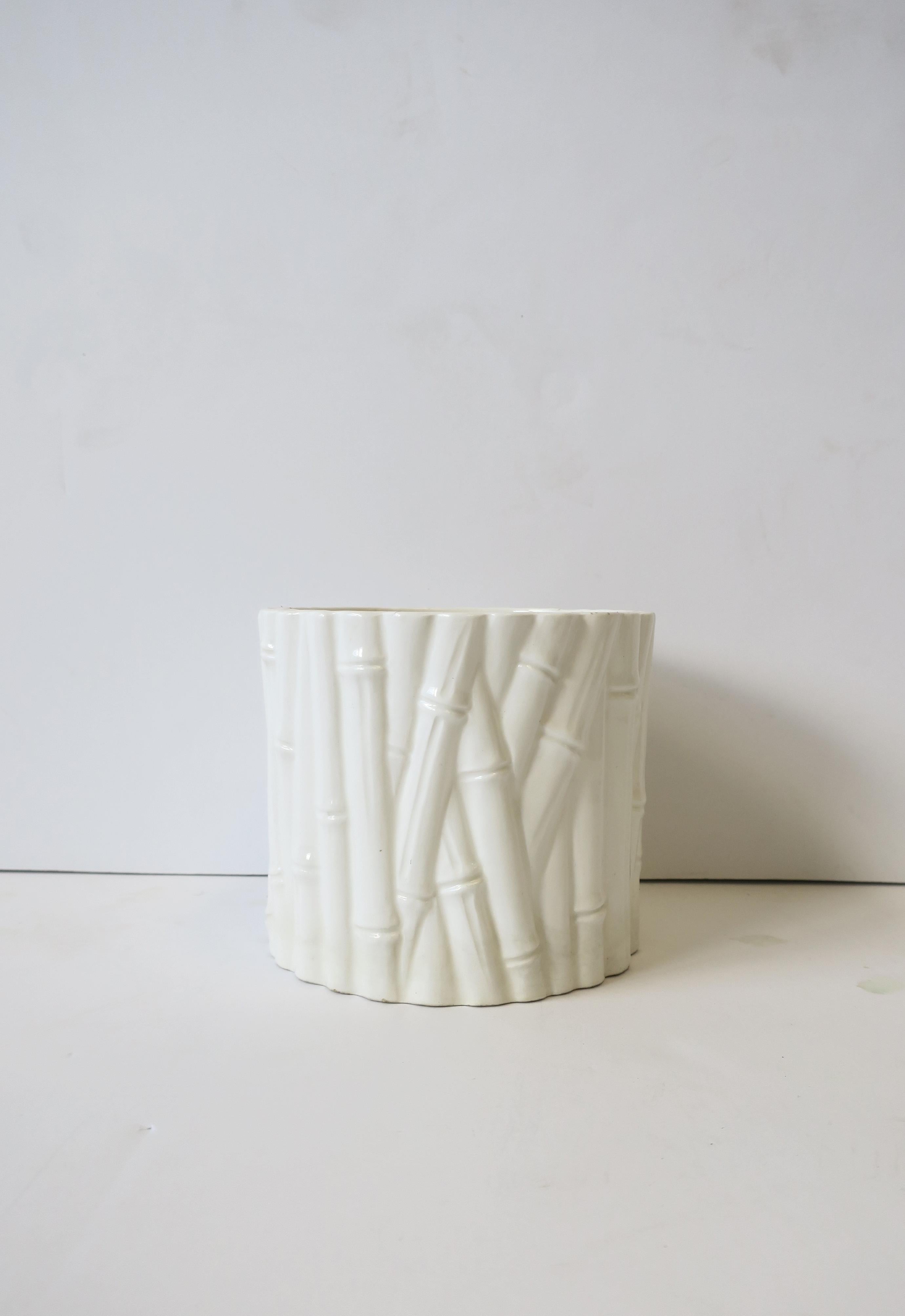 A round white ceramic cachepot or jardiniere with bamboo design, circa late 20th century, 1970s. Shown holding small flowering plant. Dimensions: 4.88