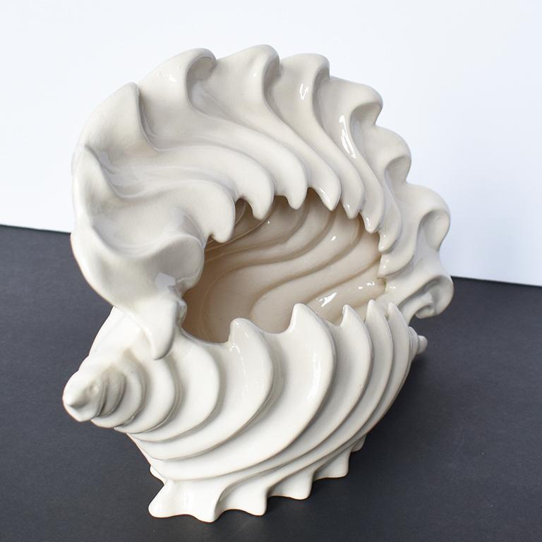 White ceramic seashell planter in the shape of a conch shell. A great way to add Hollywood Regency style to any patio or garden. 

Dimensions:
11