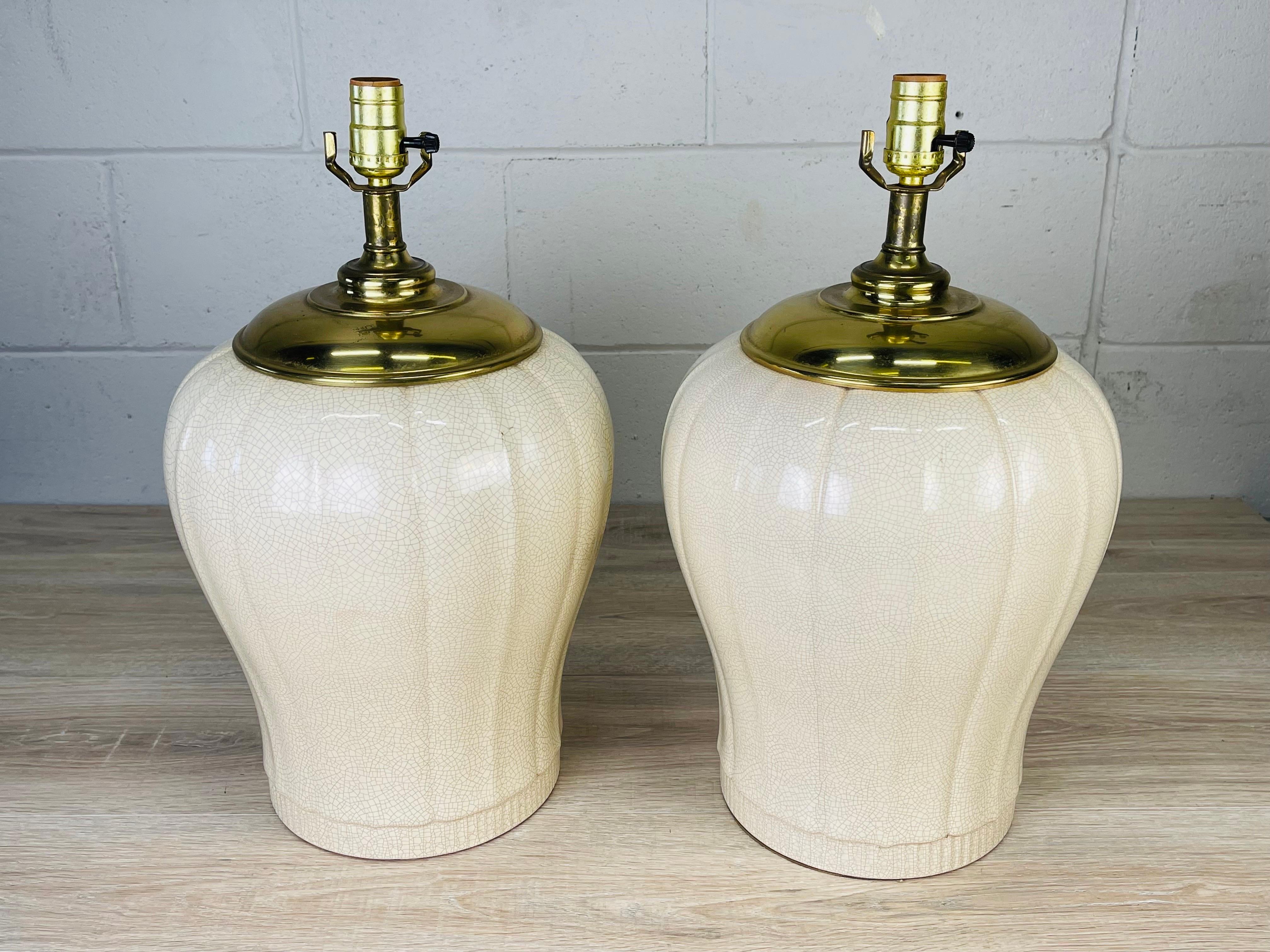 Vintage 1980s pair of ceramic white crackle table lamps. The lamps are wired for the US and in working condition. Uses standard size 100W bulbs. Harps and shades are not included. No marks.