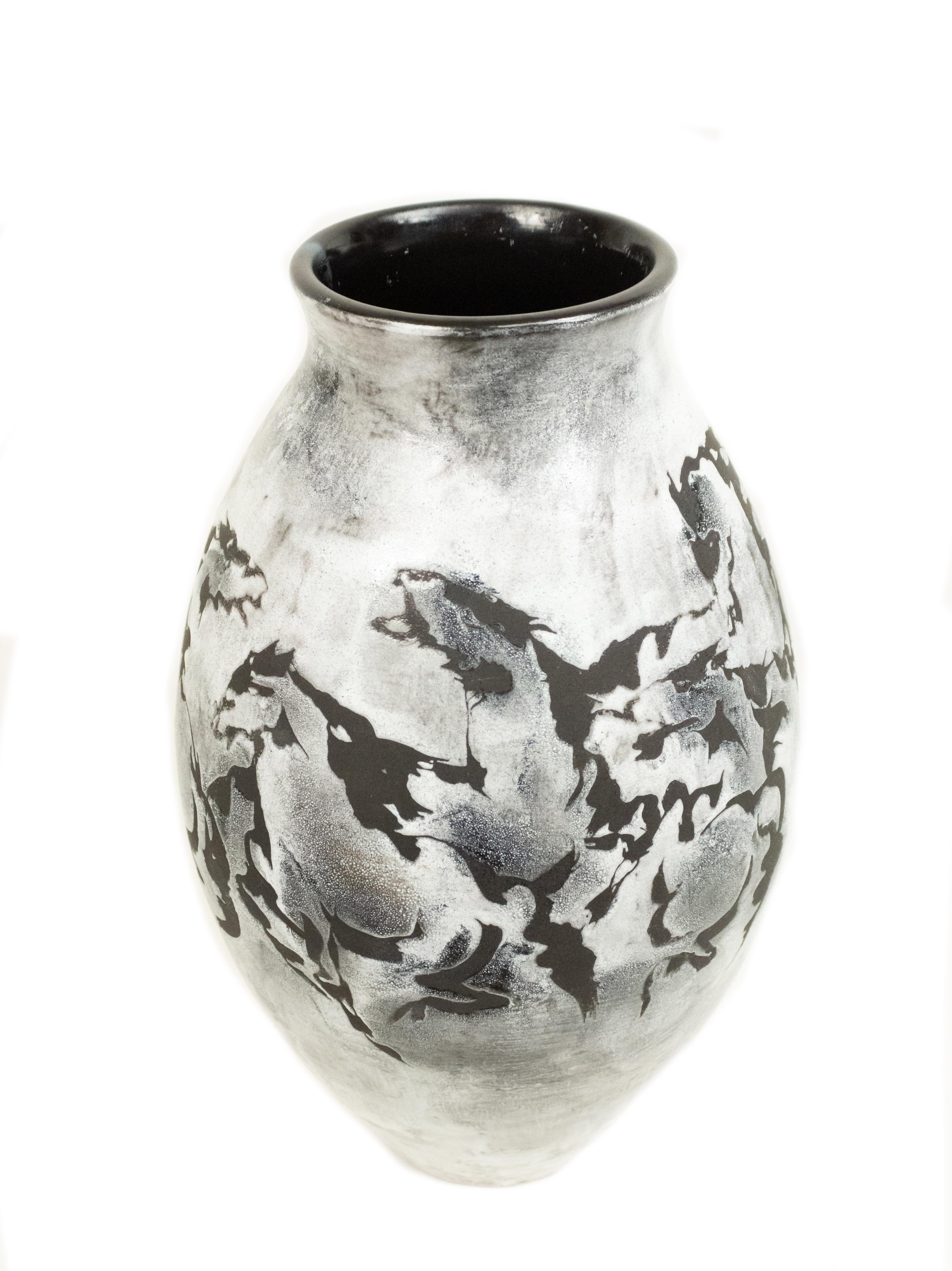 White and black vase with running horse design. Signed on bottom by maker.
