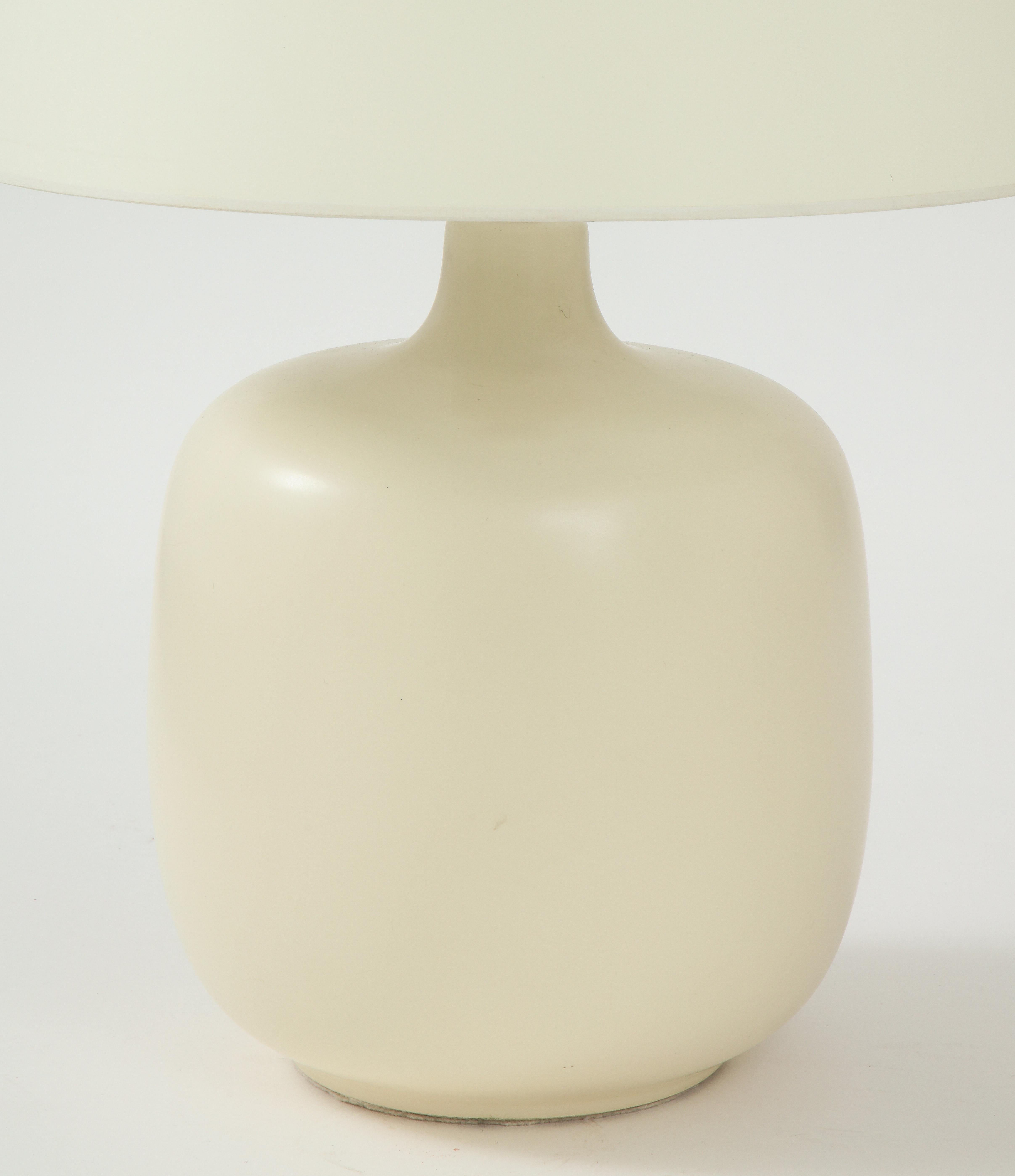 White ceramic Lotte & Gunnar Bostlund lamp with custom parchment shade, circa 1950
Bronze hardware
Newly wired, silk twist cord

Measures: Total height 25 in, vessel height 12.5, vessel diameter .9.75 in.