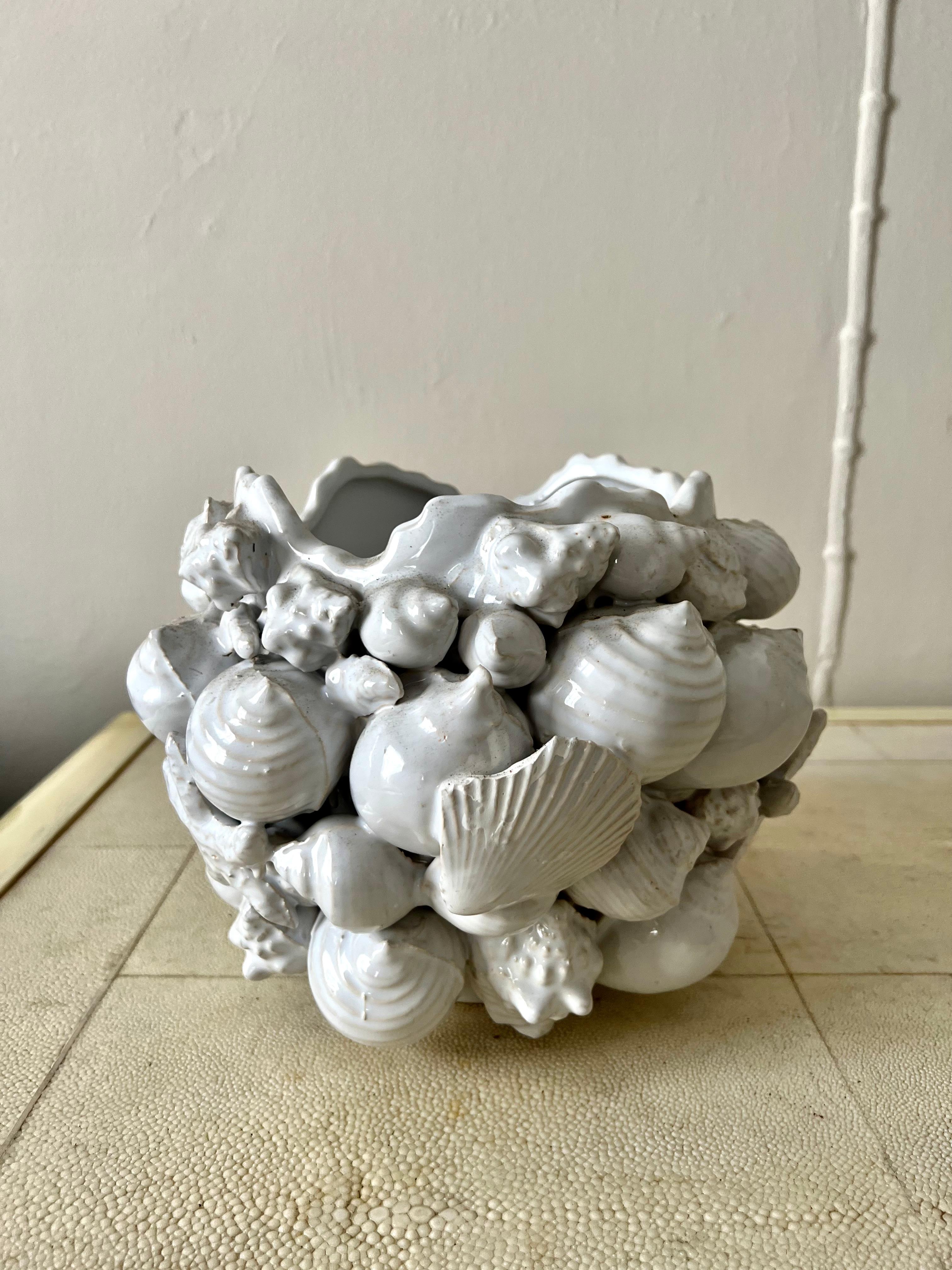 A wonderful white ceramic or porcelain planter. Appropriate for either indoors our out, on a shelf or on the patio... the piece is a compliment to many settings, especially a beach theme. While the piece would be great for plants, it does not have a