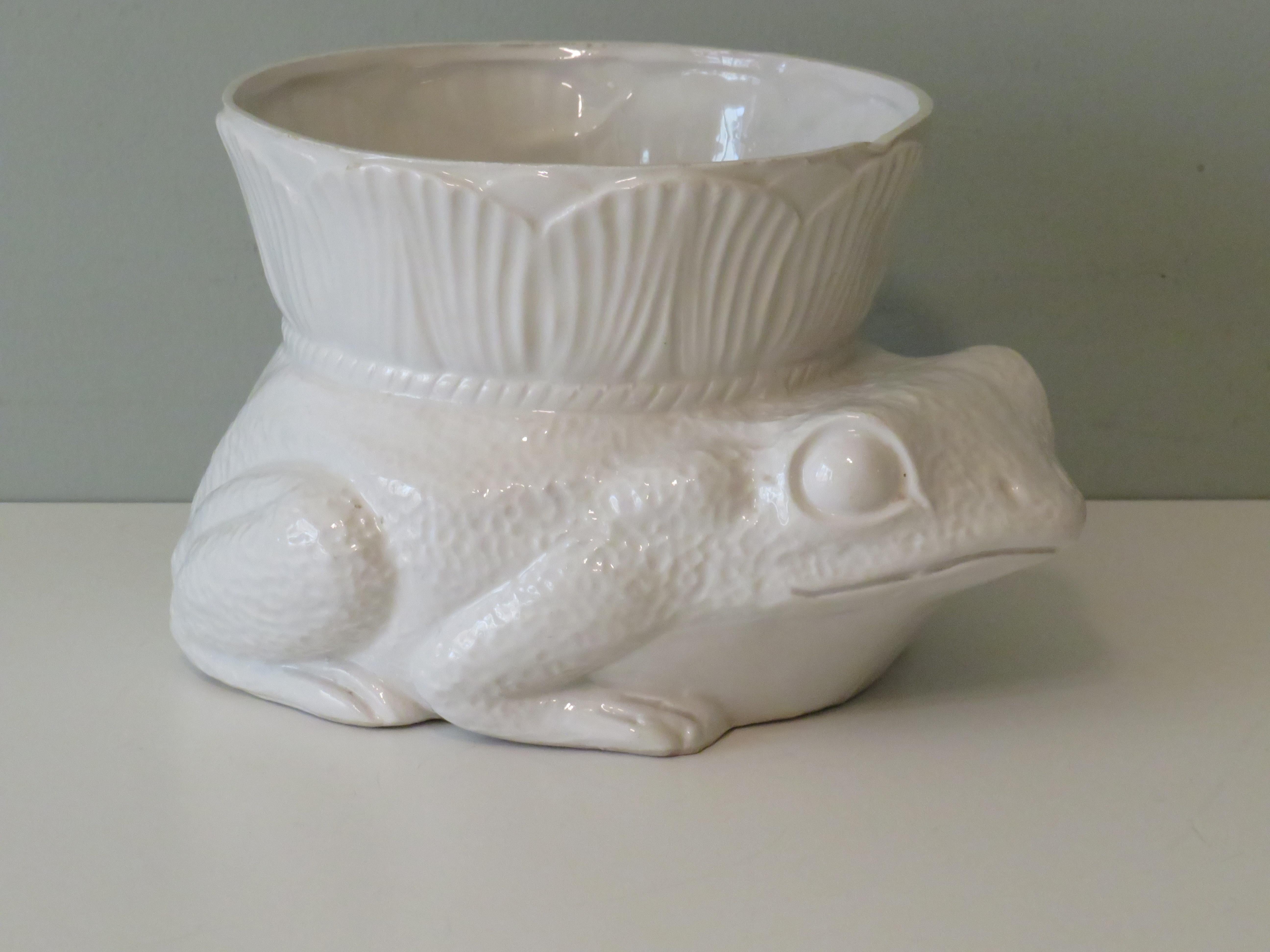Fine ceramic planter in the shape of a frog with a stand-up collar.
The dimensions are: 27 x 22 cm and the height is 15.5 cm.
The planter is suitable for an inner pot with a maximum height of 15 cm and a diameter of 16 cm that slopes downwards. At