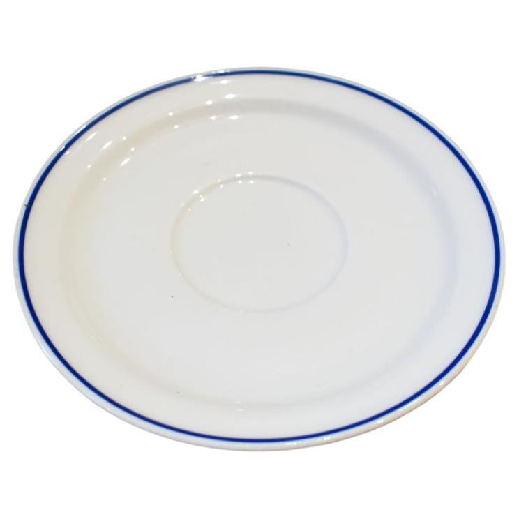 A small ceramic tea or coffee saucer in white with blue trim by Michaud for American Airlines. 

Dimensions:
5.5