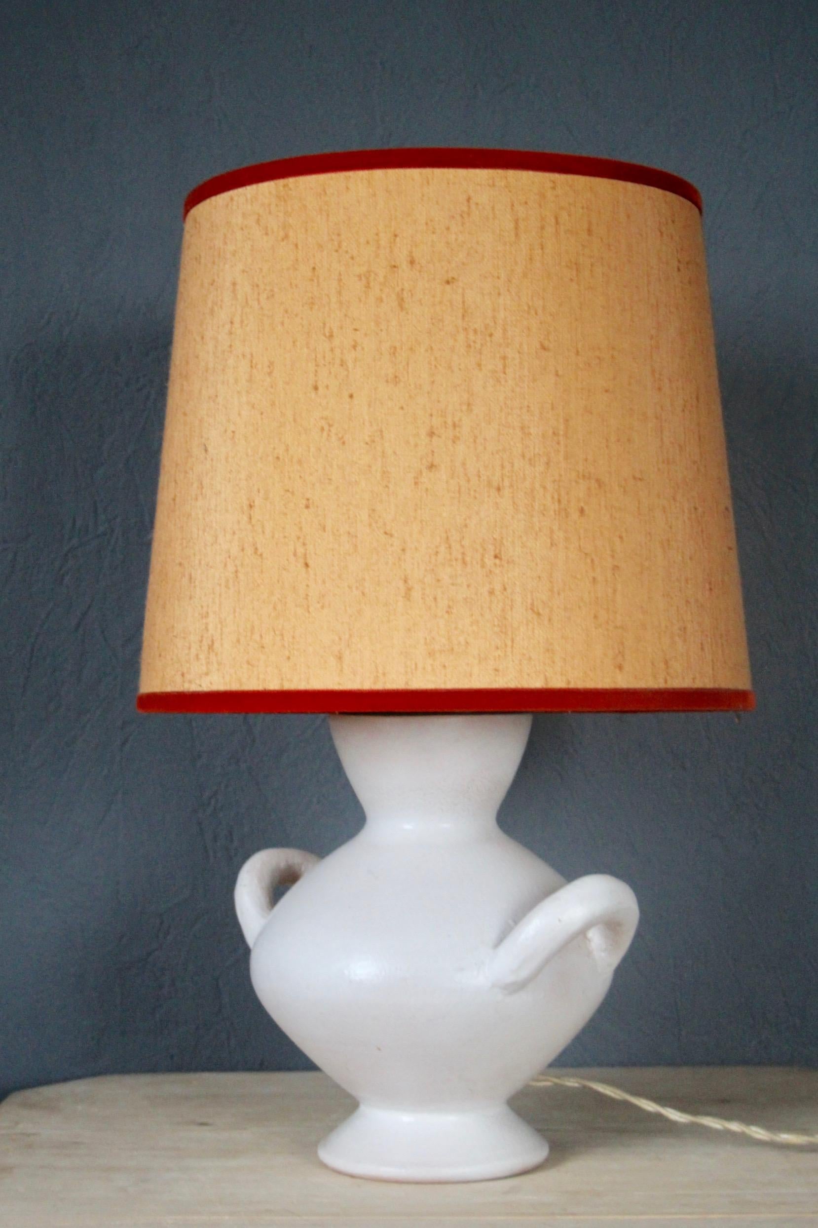 White ceramic table lamp, small damage on the shade, dimensions with out shade H 33 diam 20 cm.