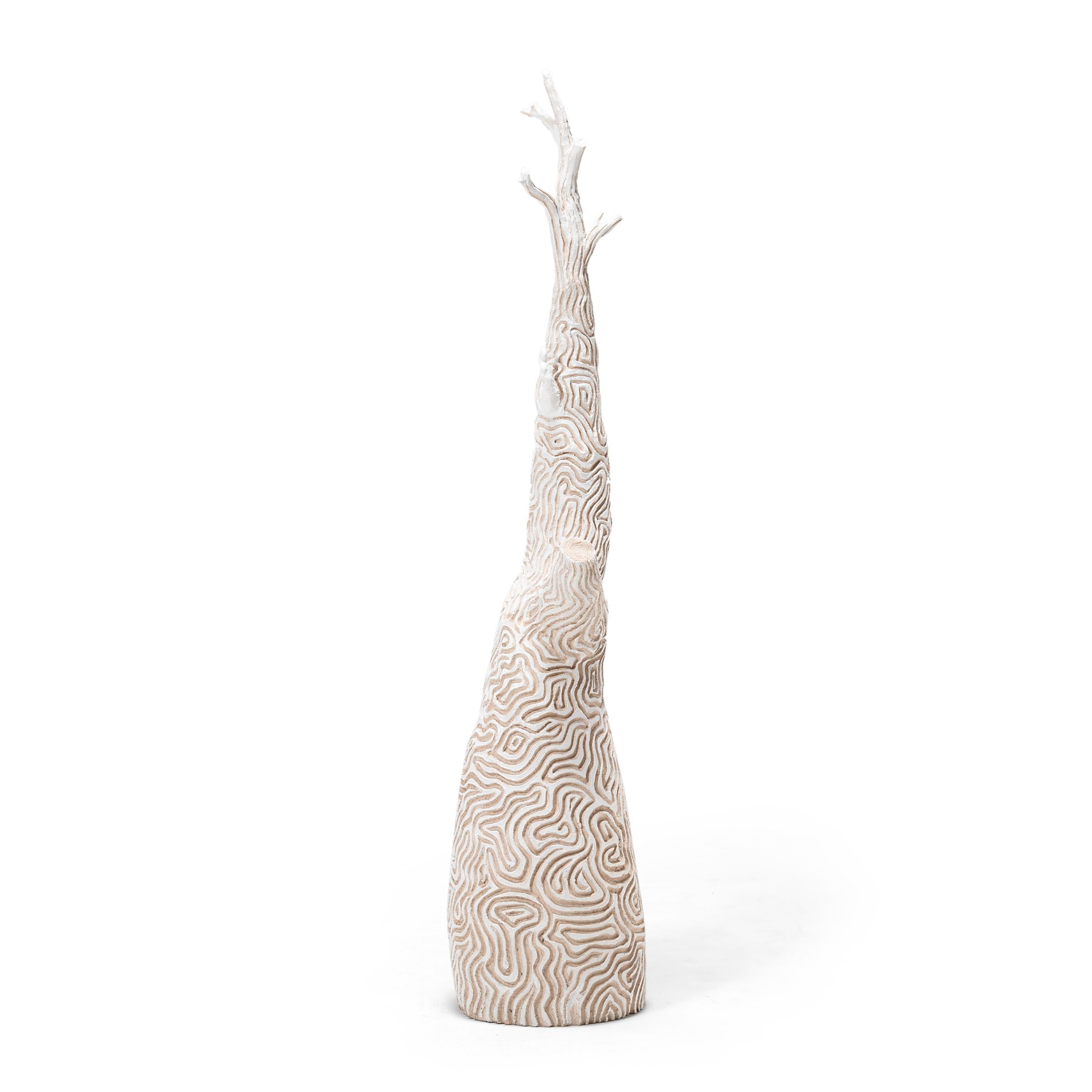 Decorated with meandering incised linework, this sculptural ceramic tree is a playful way to add texture and contrasting color to any interior. We love the petite tree as a display for hanging objects or a whimsical centerpiece.